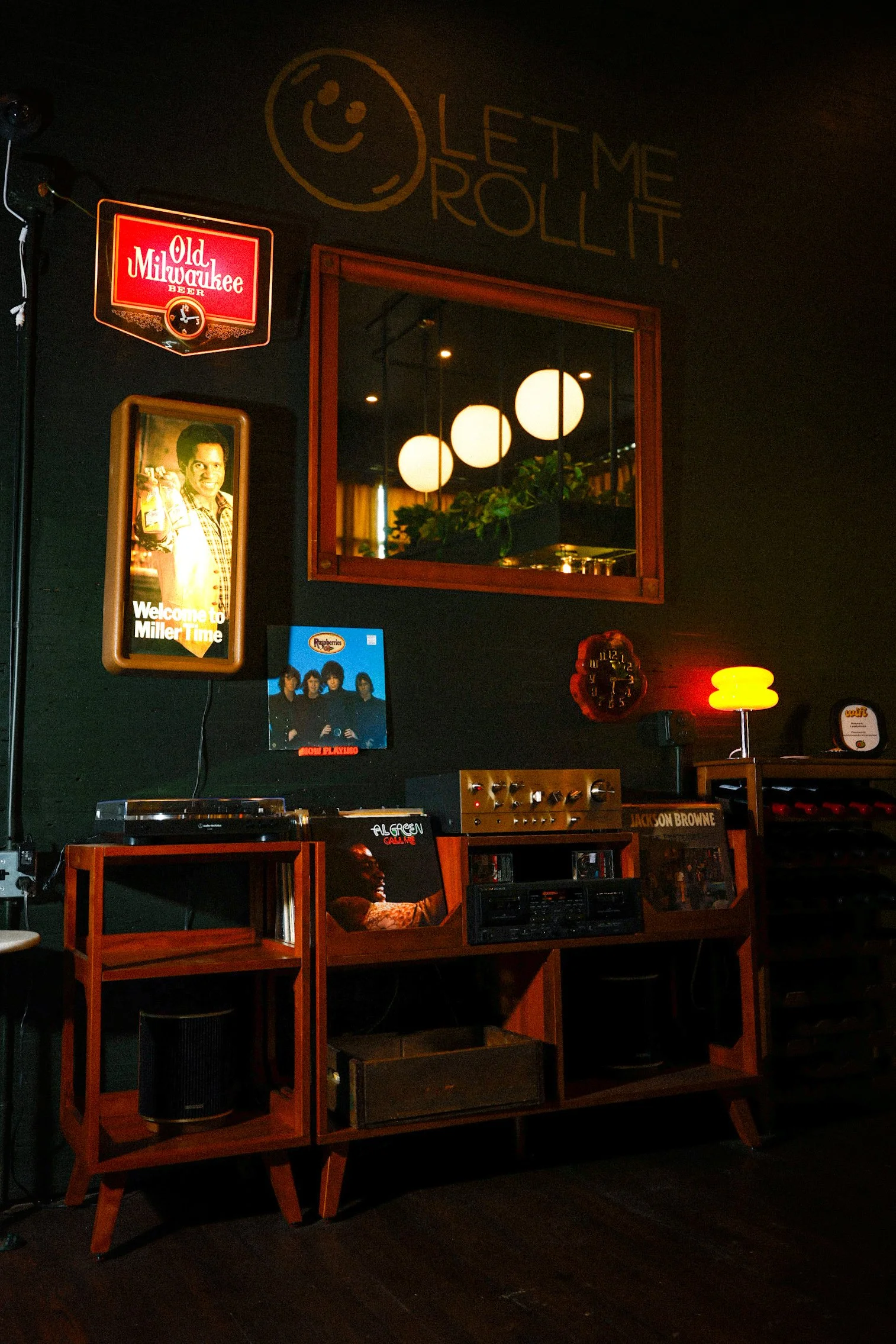 A record player and cassette player with vintage signs and decor