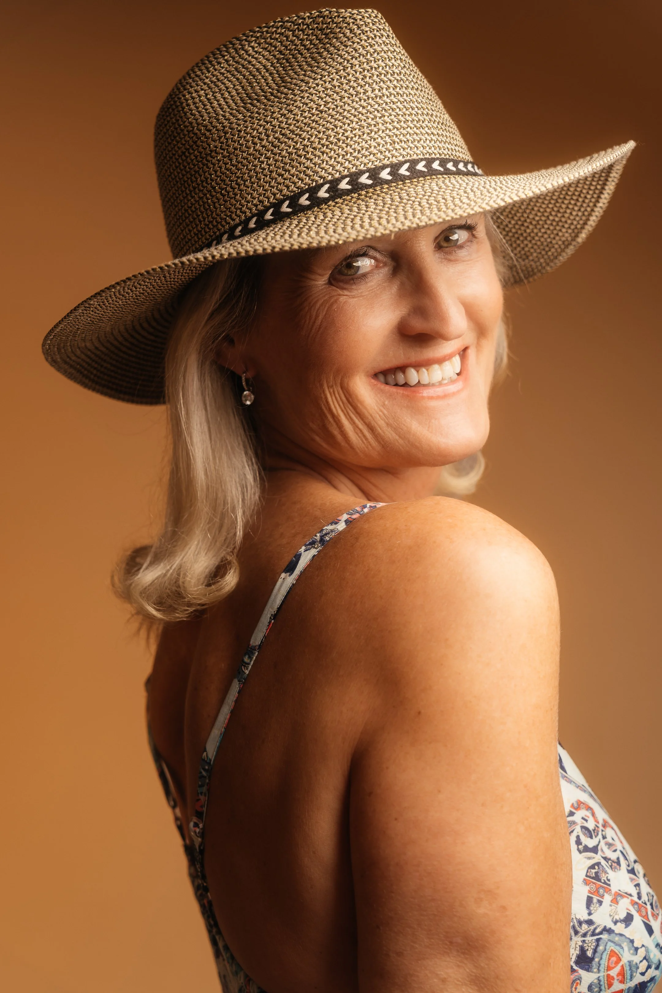 A warm and timeless portrait combining natural expression, texture and classic Western-inspired styling.