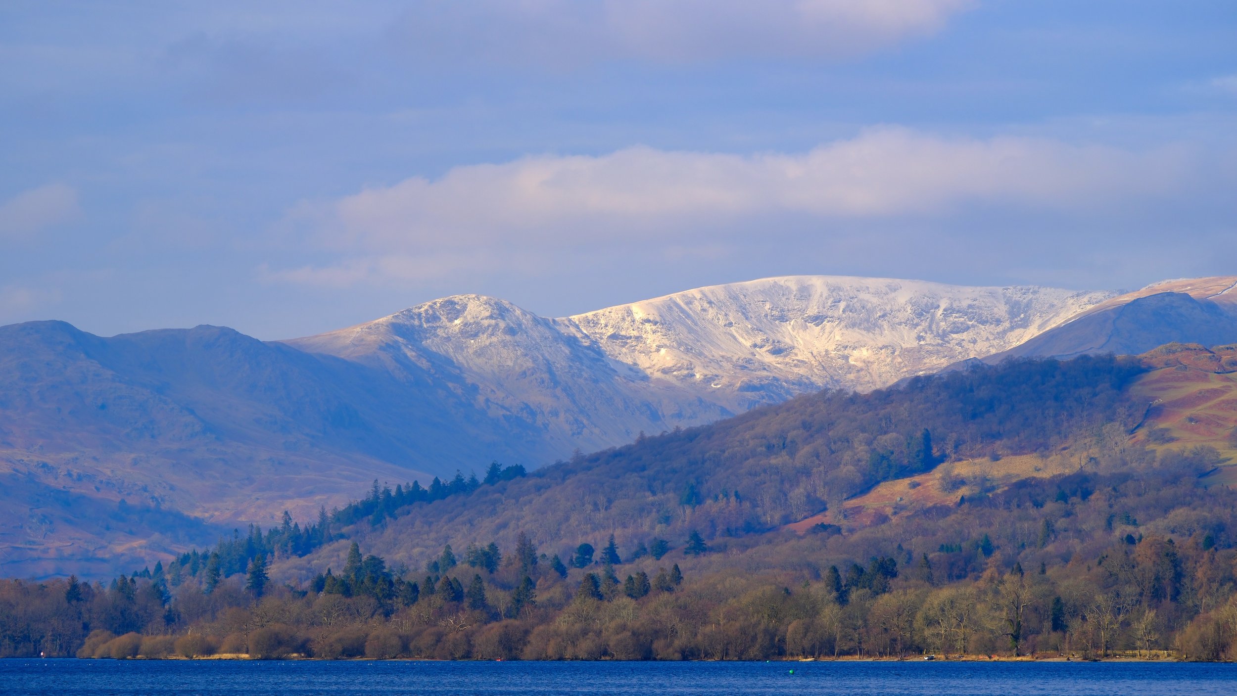 "Fairfield Flurries" The mighty Fairfield Horseshoe, the ultimate challenge for Wainwright Baggers. The snow capped fells of Heron Pike, Great Rig and Fairfield blend into the tree line above Ambleside