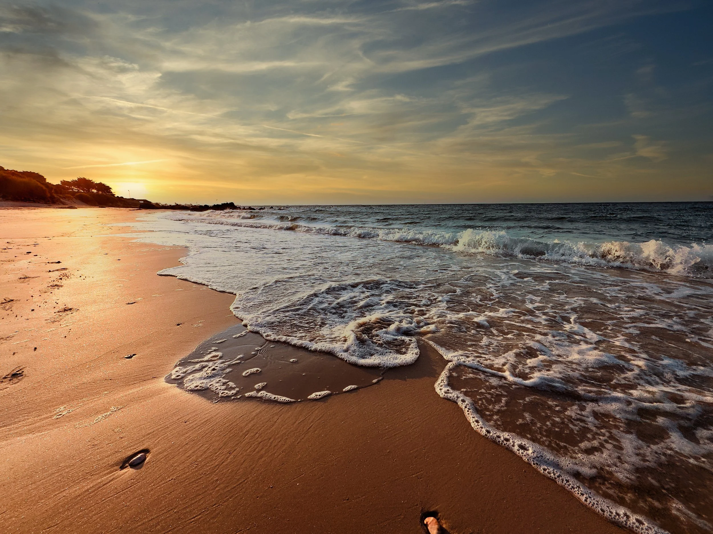 "Beach Bubbles" Taken on Carnac Plage, France, sister picture to "Beach Bubble" capturing the breaking sunrise in the distance. Swirling water again leaving its mark in the soft sand. The sun will continue to ignite the distant sky and evaporate the 