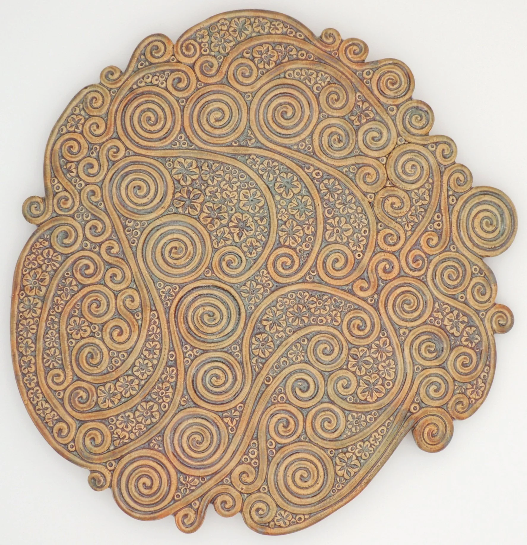 Decorative wooden carving with intricate swirling and floral patterns.