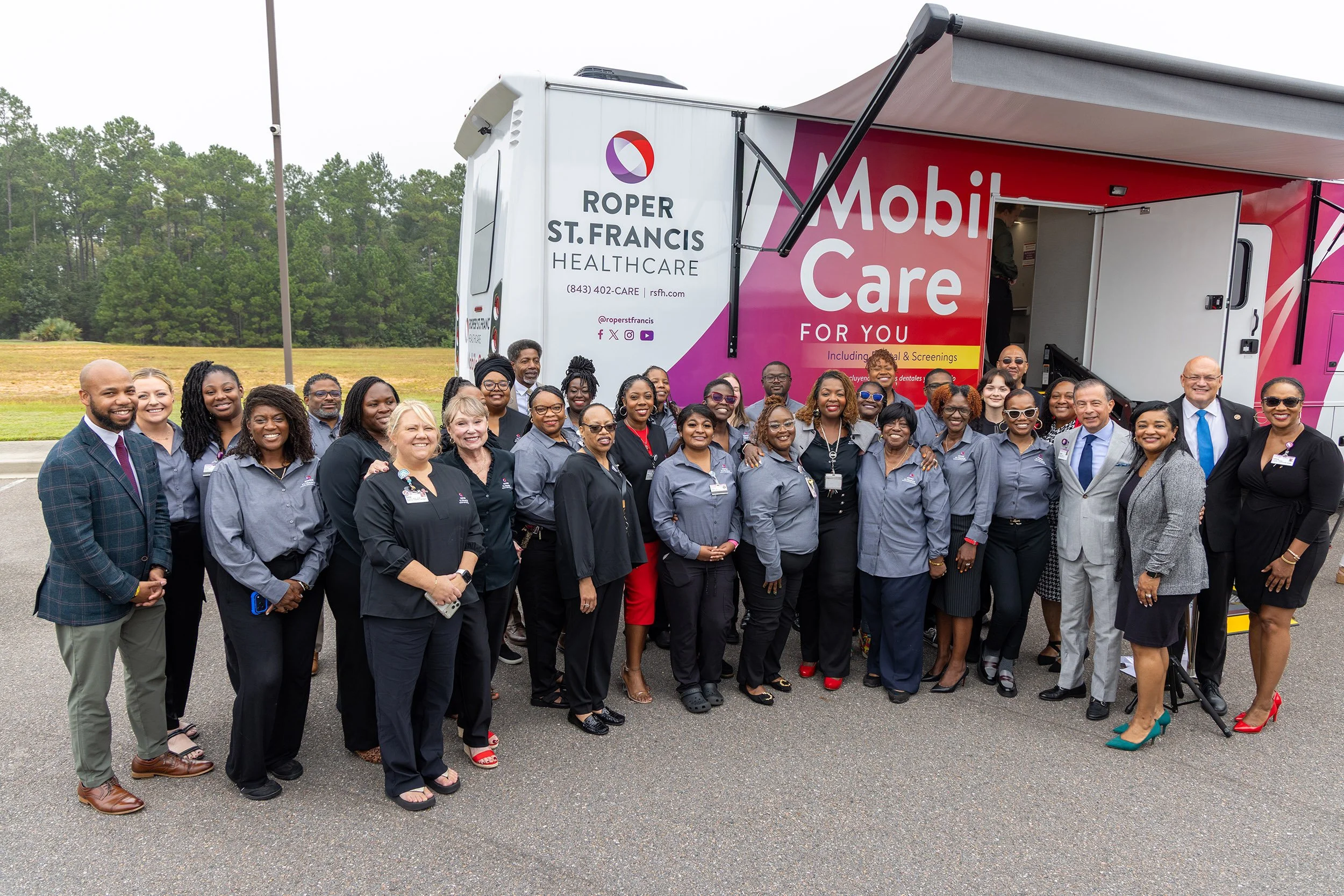 people standing in front of a clinical mobile unit