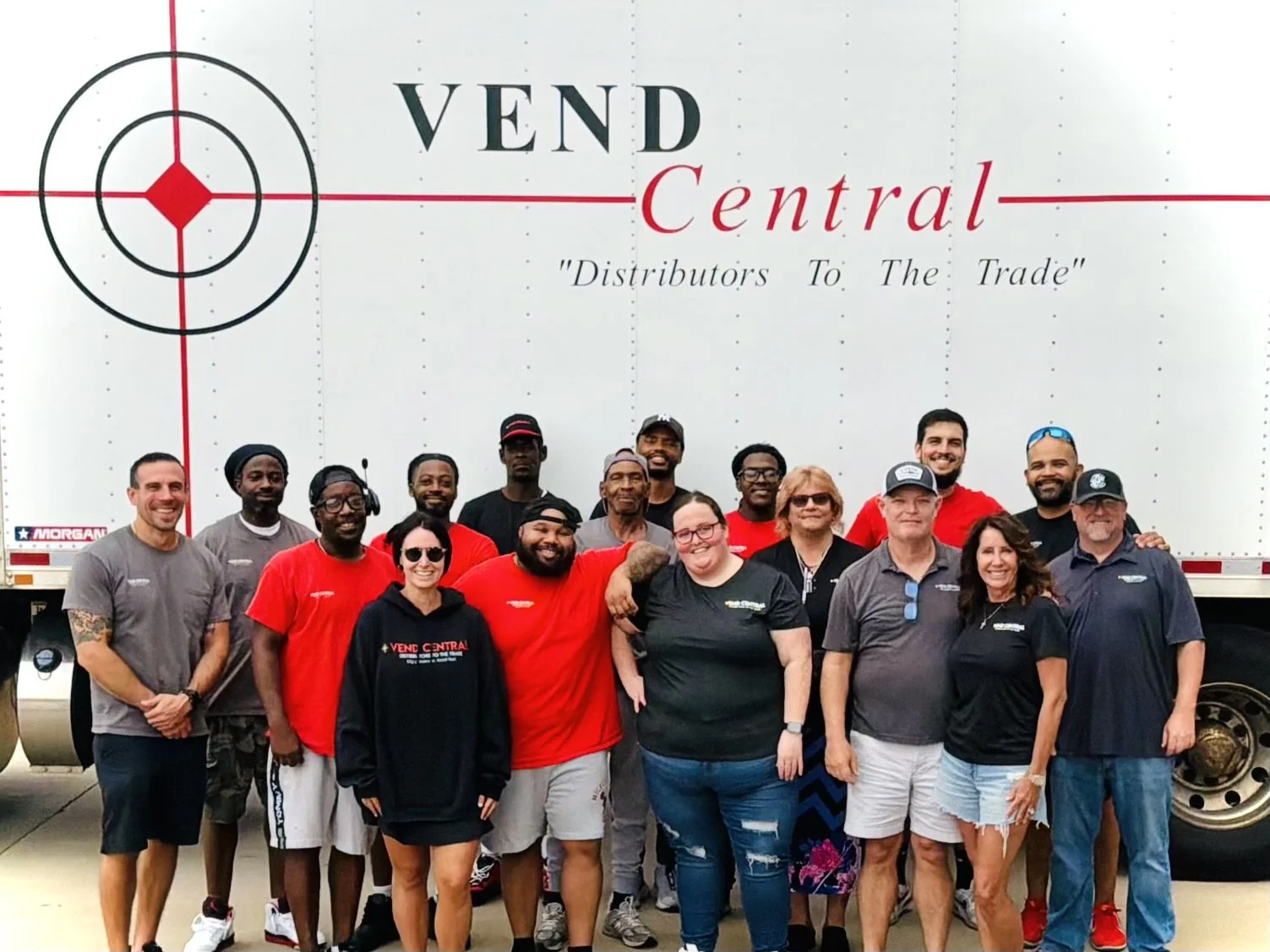 Group of people standing in front of a Ven Central truck.