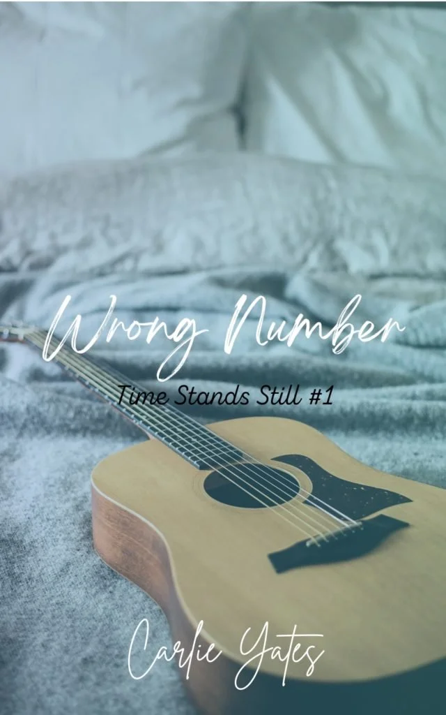 Book cover of Wrong Number Time Stands Still Book 1. Guitar laying on a made bed.