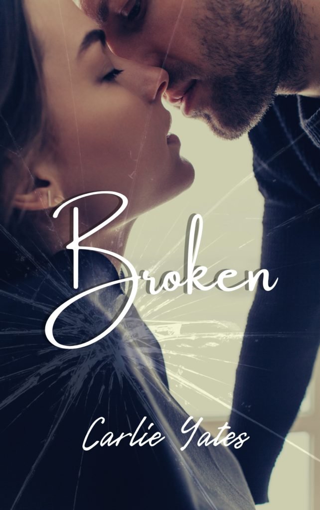 Broken in white text on a background with a man kissing a woman.  The cover looks shattered like a piece of glass.
