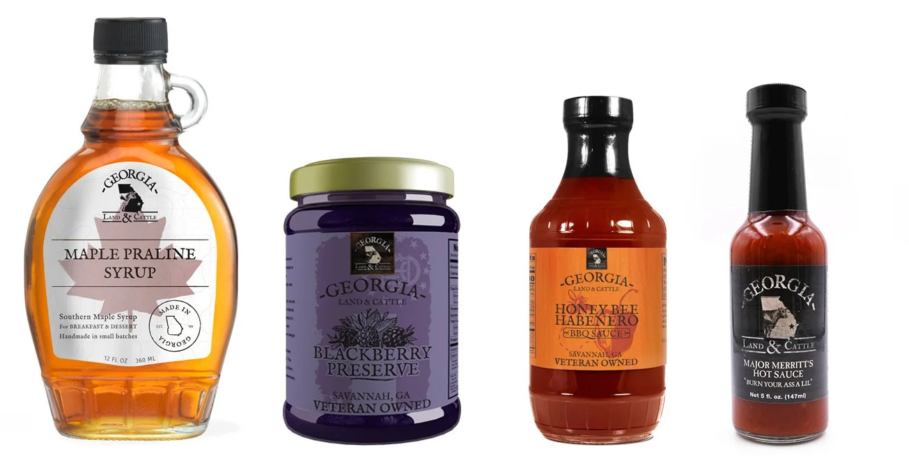 Collection of four Georgia land and cattle branded food products, including maple praline syrup, blackberry preserve, honey bee habanero BBQ sauce, and major Merritt's hot sauce.