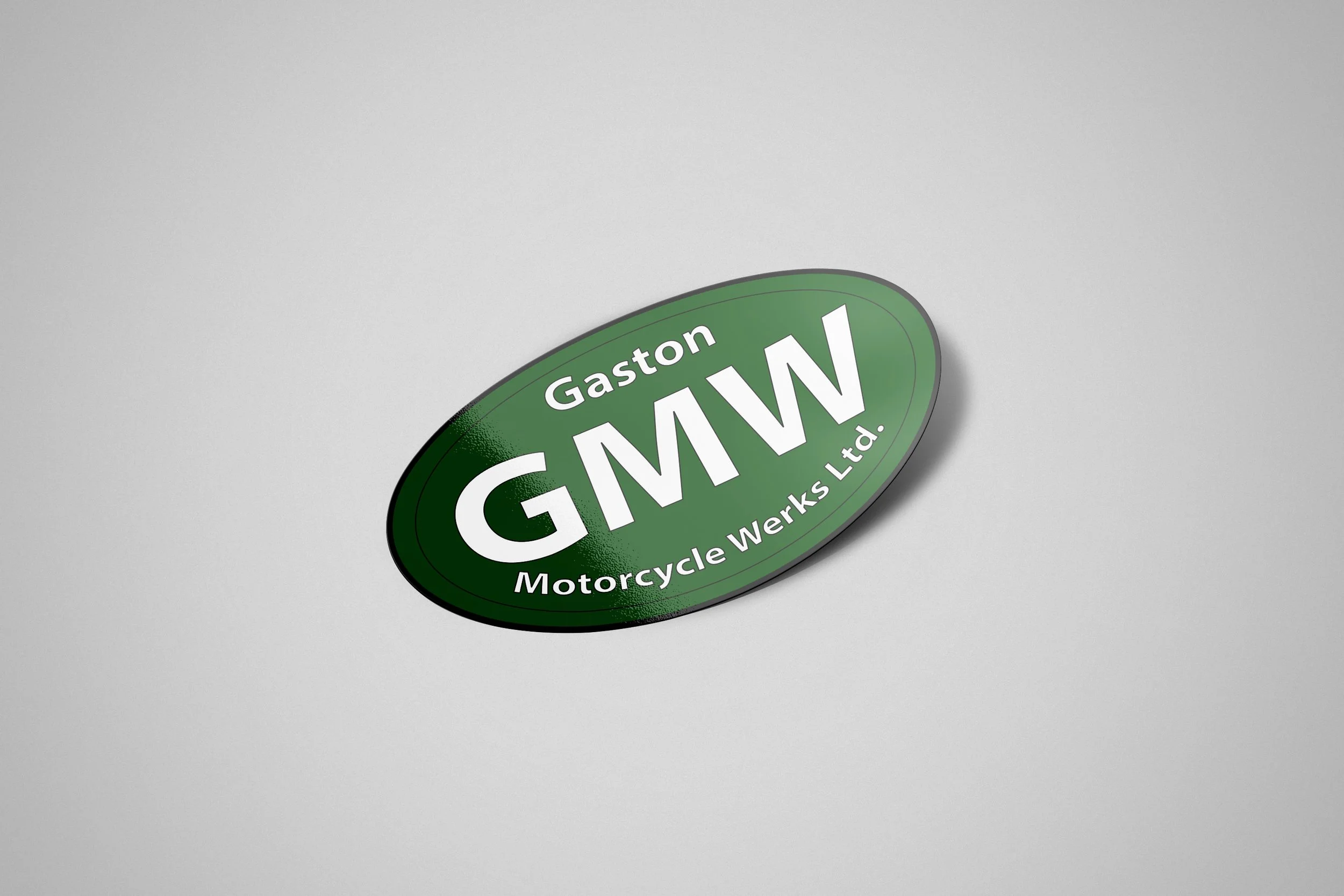 Green oval sticker that reads "Gaston Motorcycle WERKS Ltd." on a light gray background.