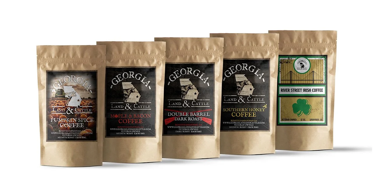 Five bags of Georgia Land & Cattle coffee flavors including Pumpkin Spice, Maple & Bacon, Double Barrel Dark Roast, Southern Honey Coffee, and River Street Irish Coffee.