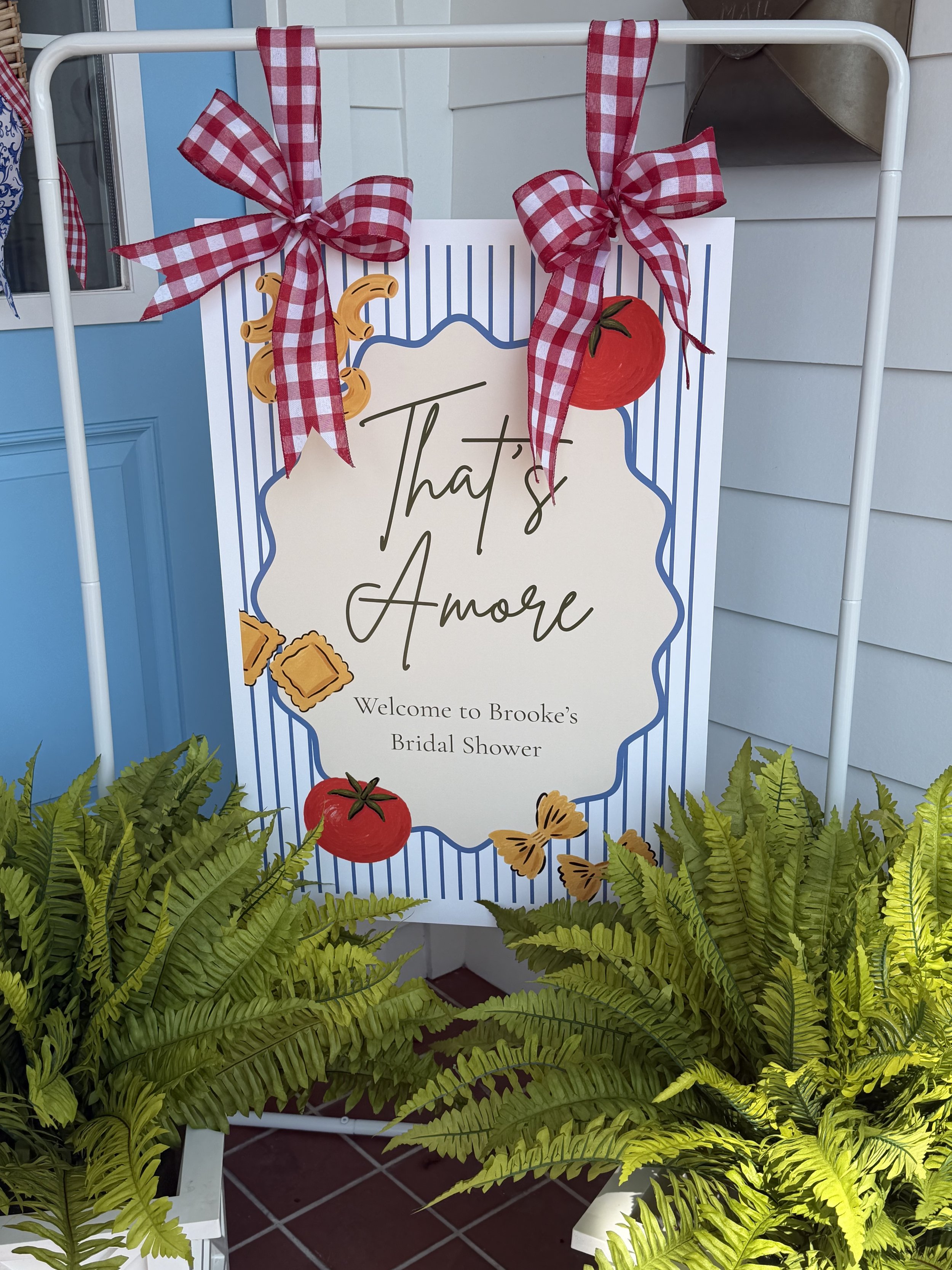 Close-up of a custom FSU-themed welcome sign framed by red, blue, and white decorations and greenery.