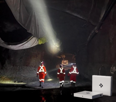 Three firefighters in reflective gear walking through a dark, flooded tunnel with a flashlight shining ahead, and equipment on the ground.