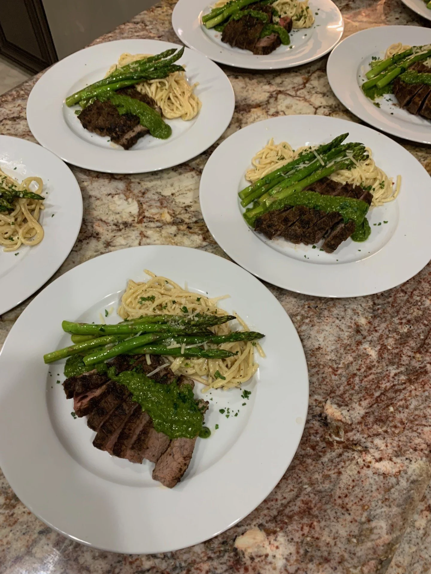 Gourmet steak with chimichurri sauce, asparagus, and pasta plated by a private chef in Phoenix.