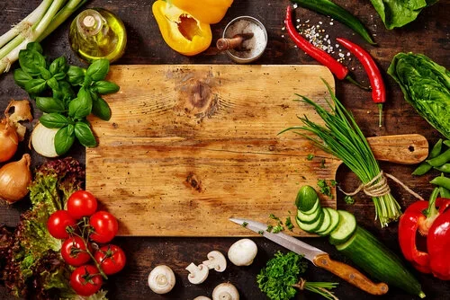 Answers from Chef Dean culinary questions and FAQ banner featuring fresh ingredients like tomatoes, basil, and peppers on a wooden cutting board.