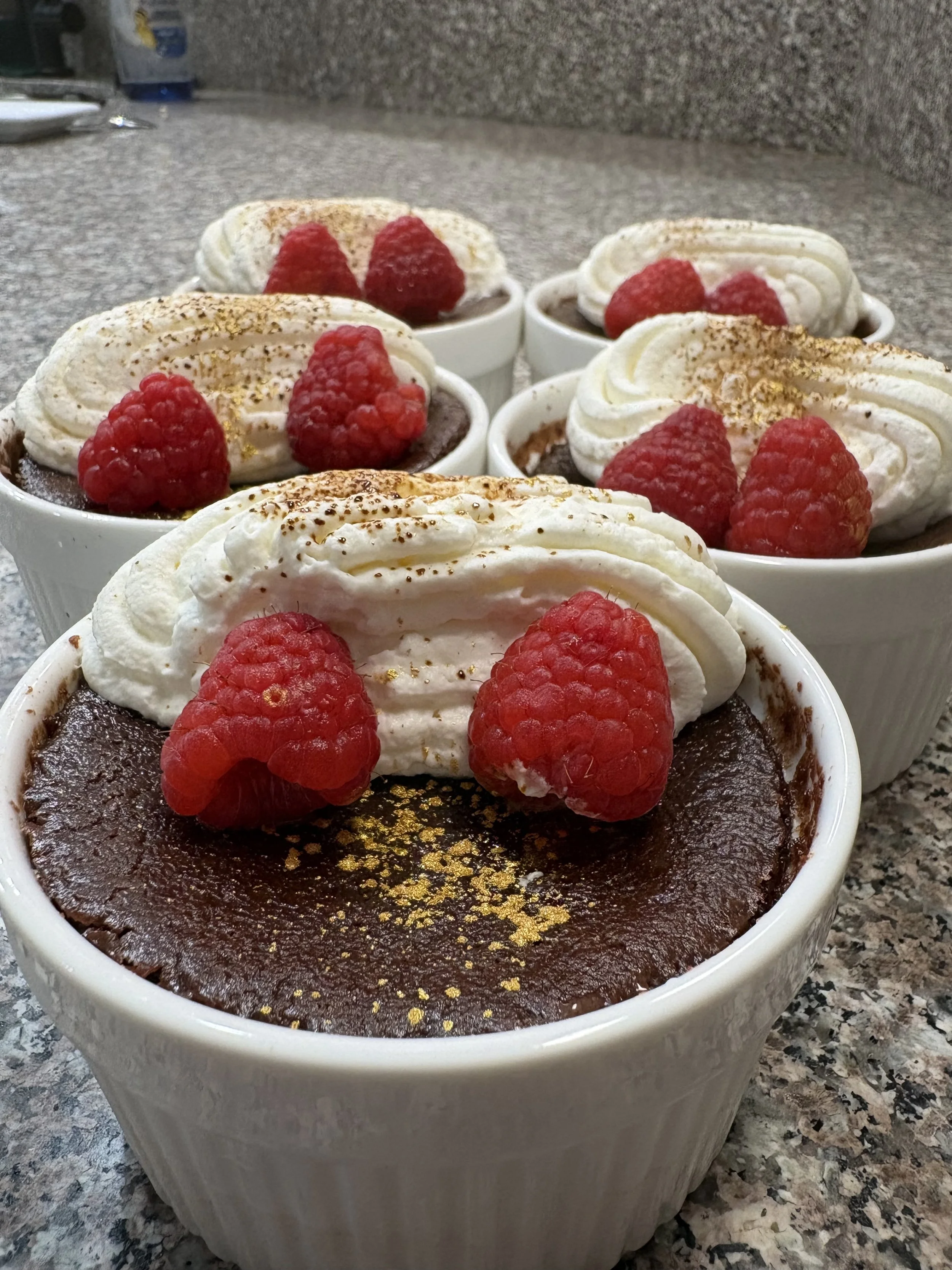 Dark Chocolate Pot de Crème topped with Chantilly whipped cream, served as the ‘Traitor Reveal’ dessert.