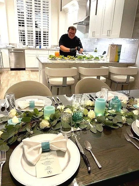 Personal chef prepping a multi-course private dinner party in a luxury Scottsdale home kitchen.