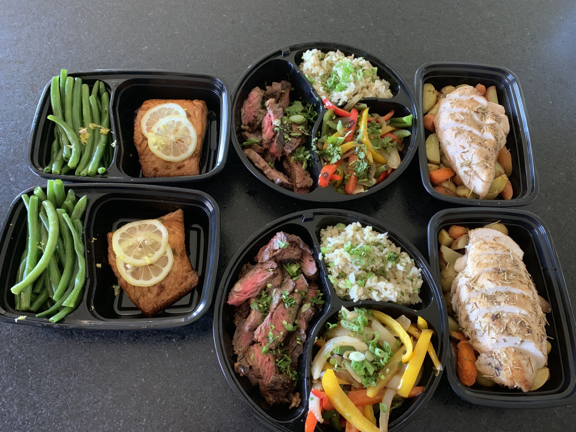 Customized private chef meal prep samples showcasing portion-controlled healthy meals of salmon, steak and chicken.
