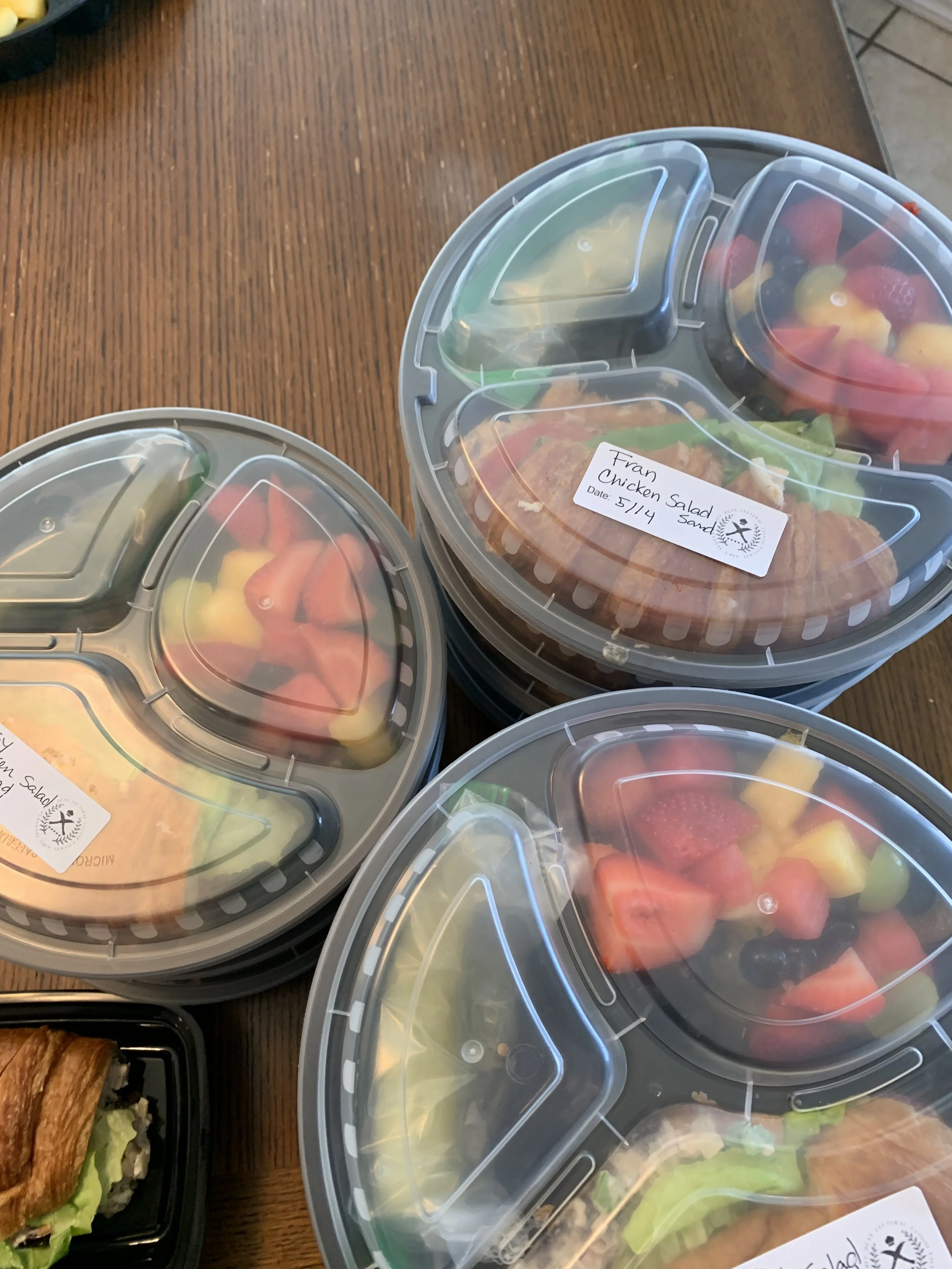 Customized client meal delivery containers with clear lids and fresh food from a Phoenix private chef.