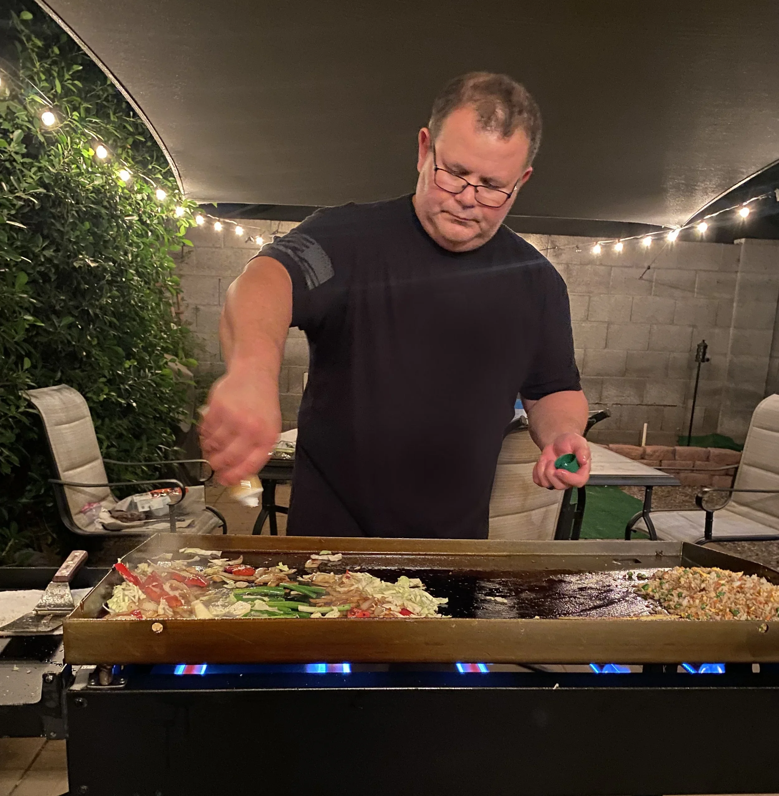 Chef Dean of Chef Dean Cultural Cuisine interacting with Hibachi style on a flat top at a private event in Phoenix.