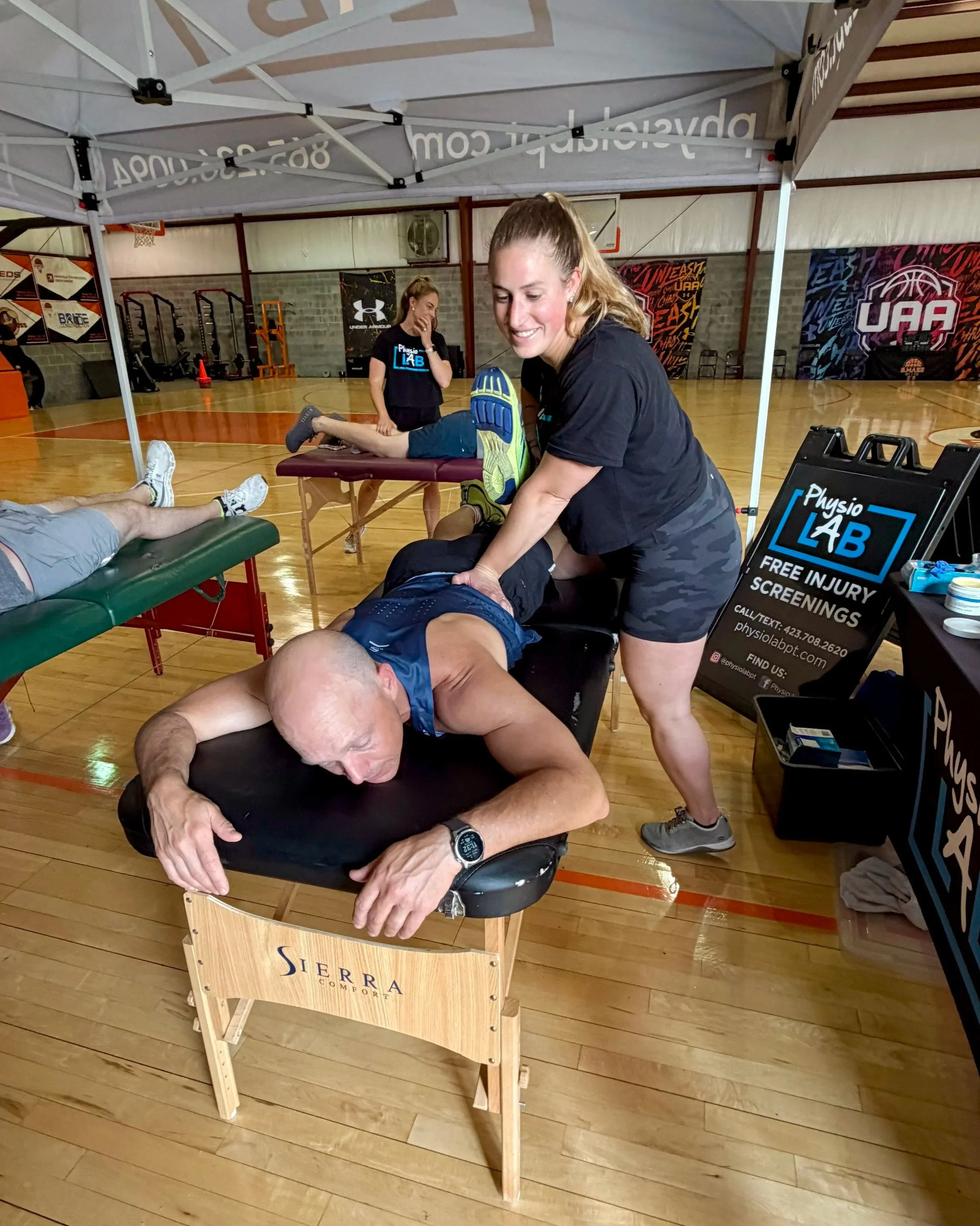 An athlete laying on a table while a provider works on his back