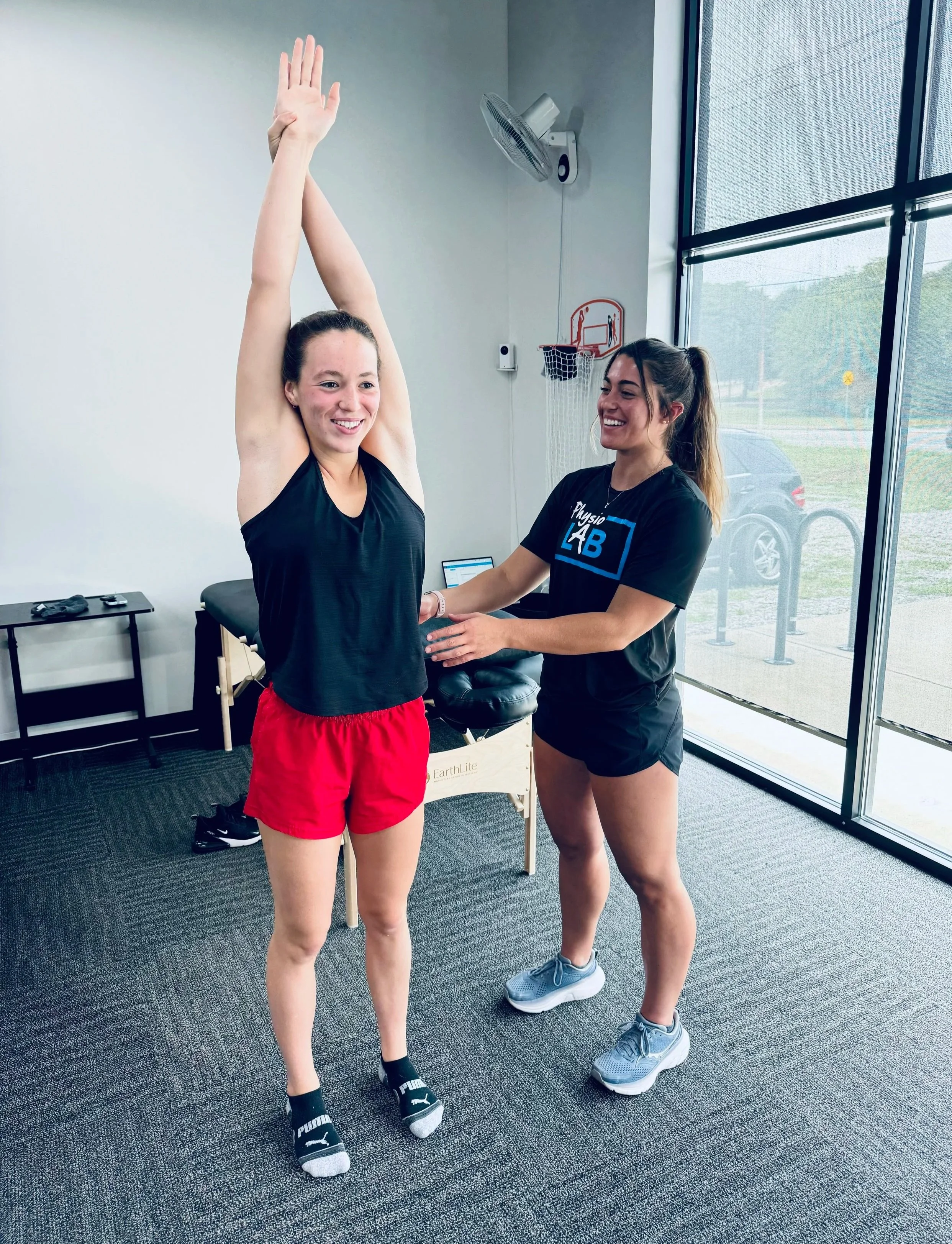 A PT working with her patient in a clinic setting
