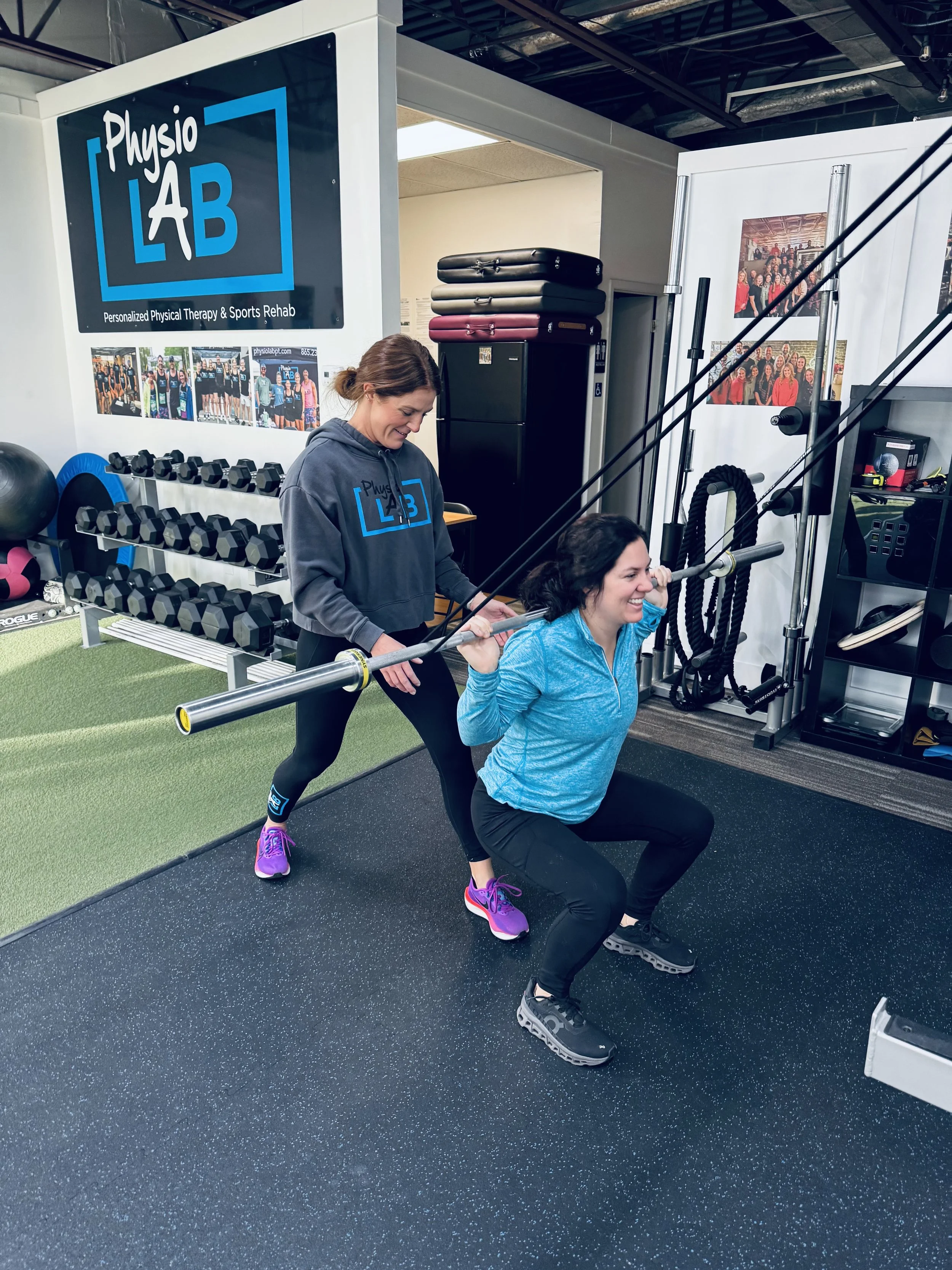Lauren Levko, PT, DPT, working with a patient doing a back squat