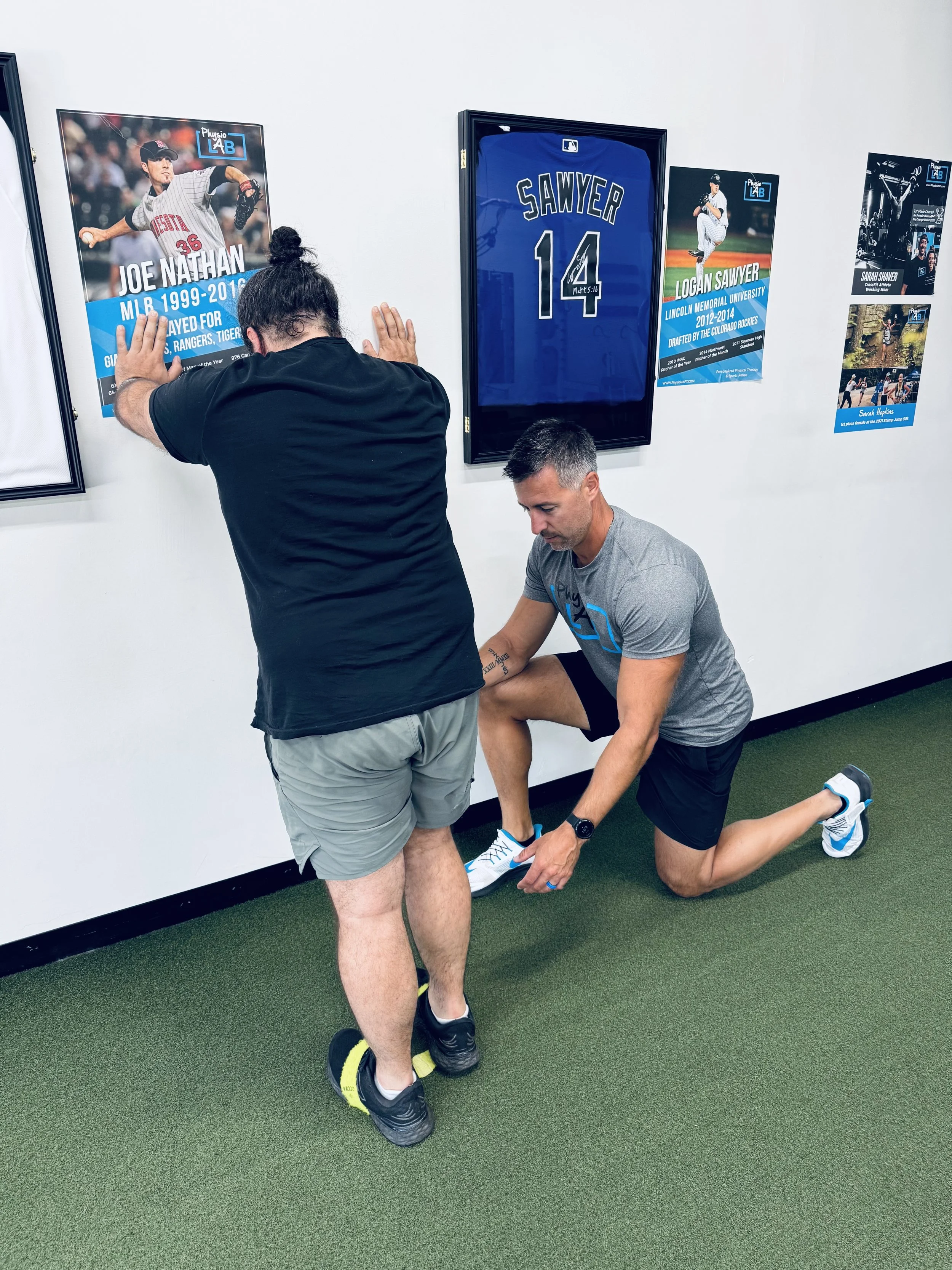 Adam Levko, PT, DPT, evaluating a patient's ankle