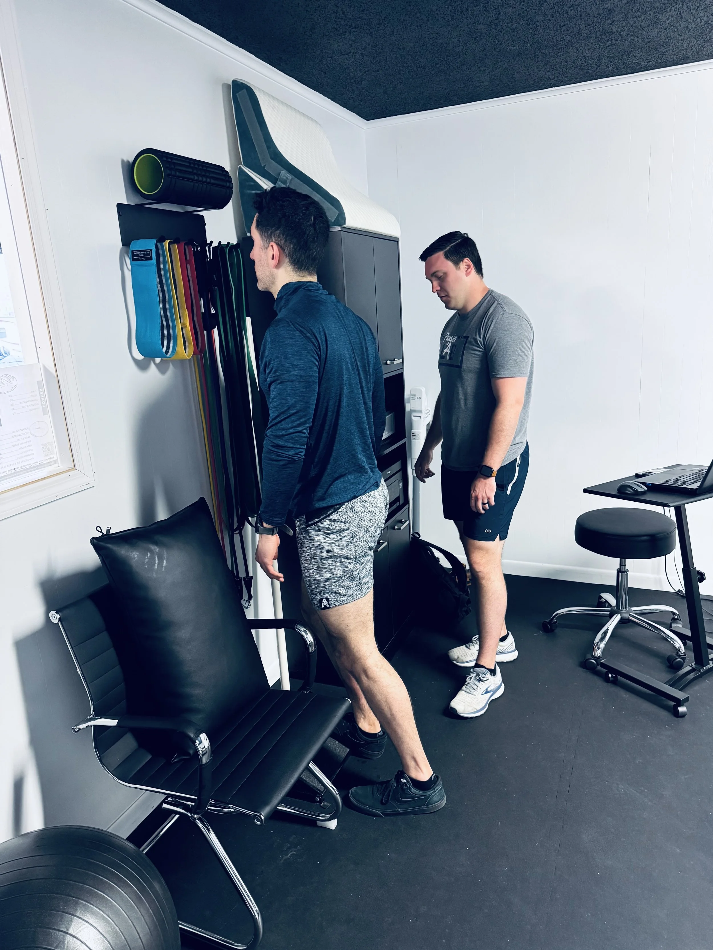 Tyler Menees, PT, DPT, evaluating a patient