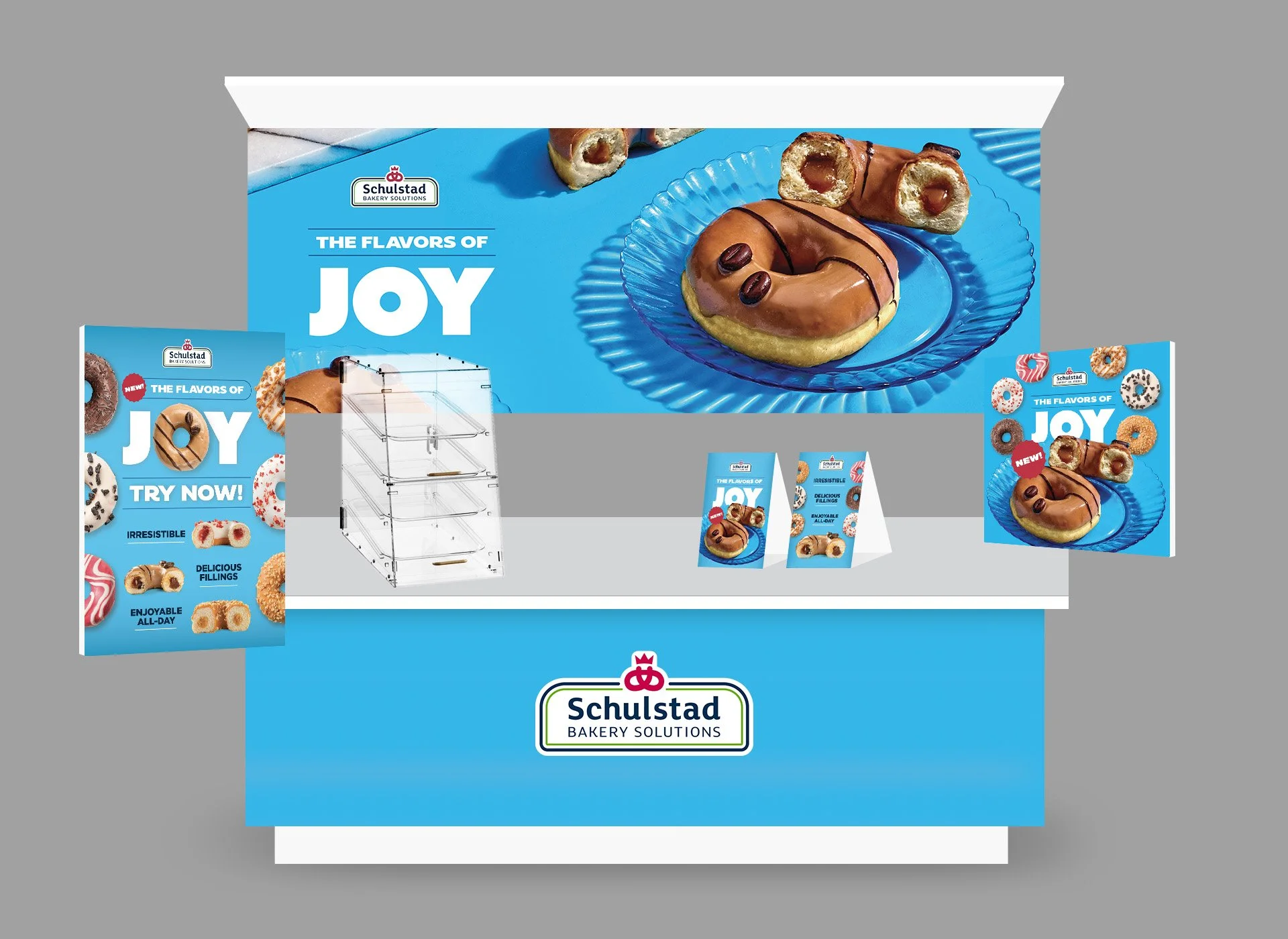 Display advertising stand for Schulstad Bakery Solutions showcasing various donut products with a blue background and promotional banners.