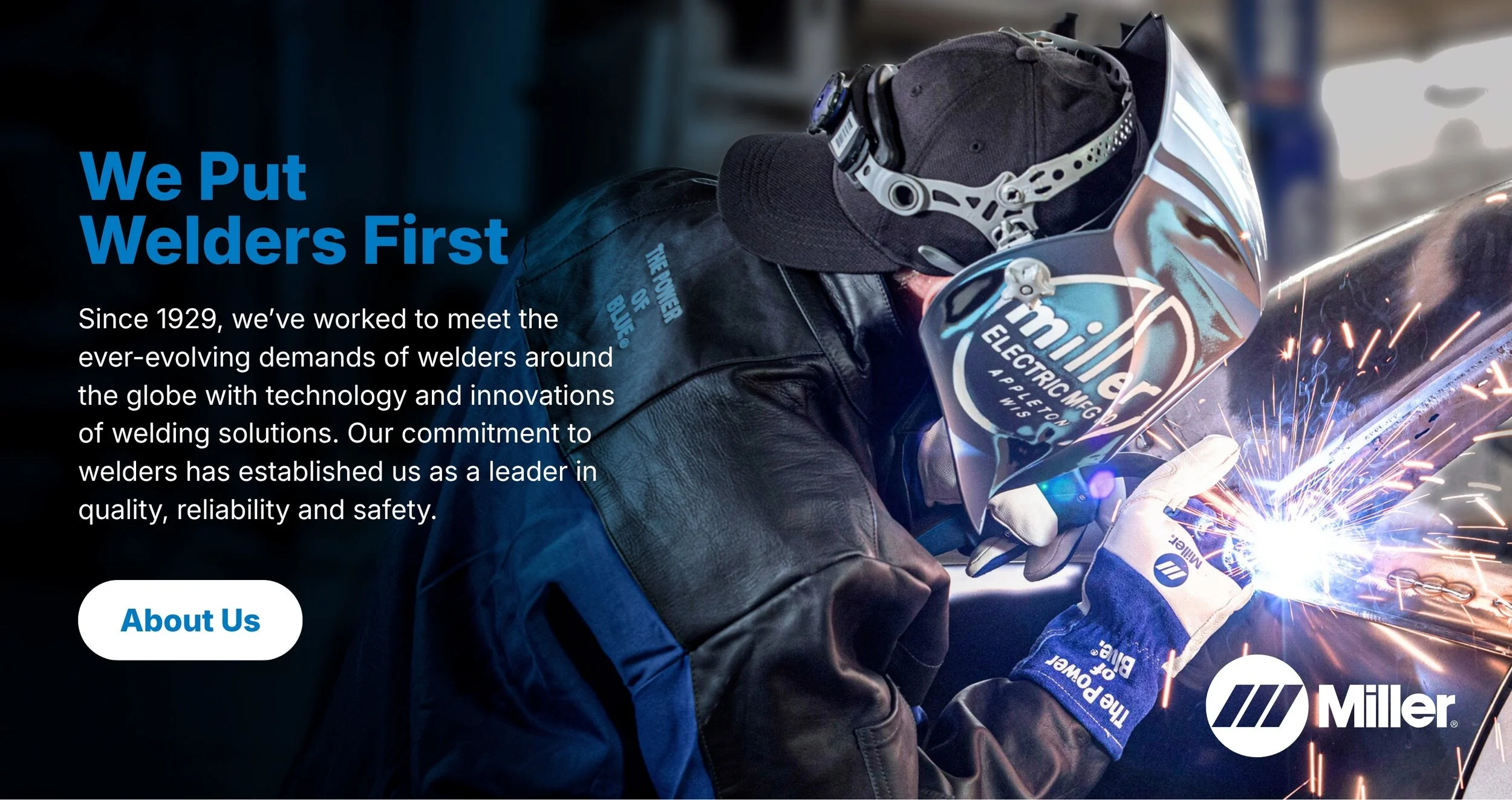 A worker welding wearing a helmet, gloves, and protective gear while sparks fly during a welding process.