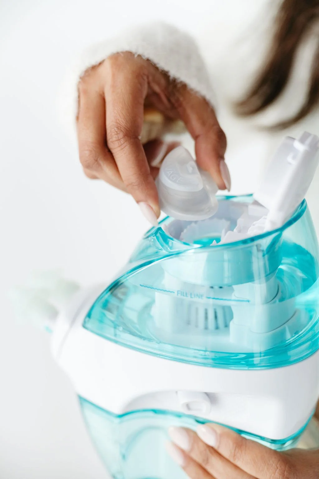 Person removing the nasal spray from a tissue box.