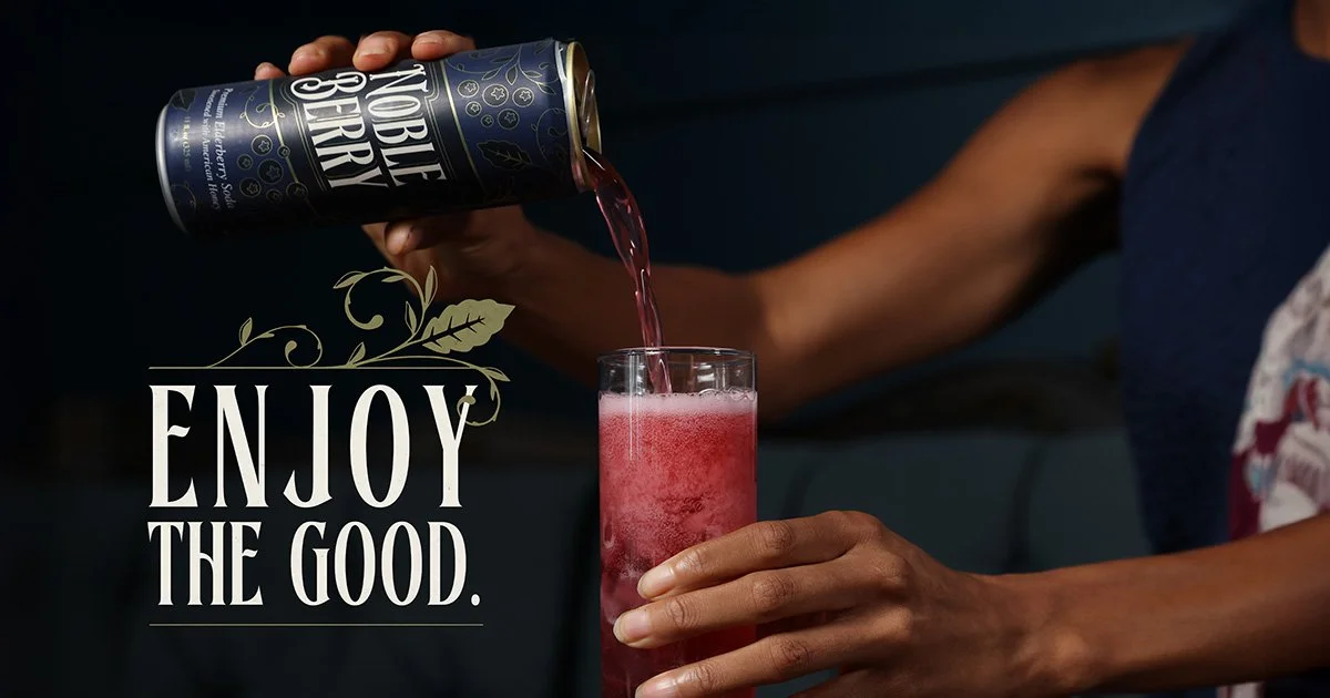 Person pouring a pink beverage from a can into a glass, with the text 'ENJOY THE GOOD' overlaid.