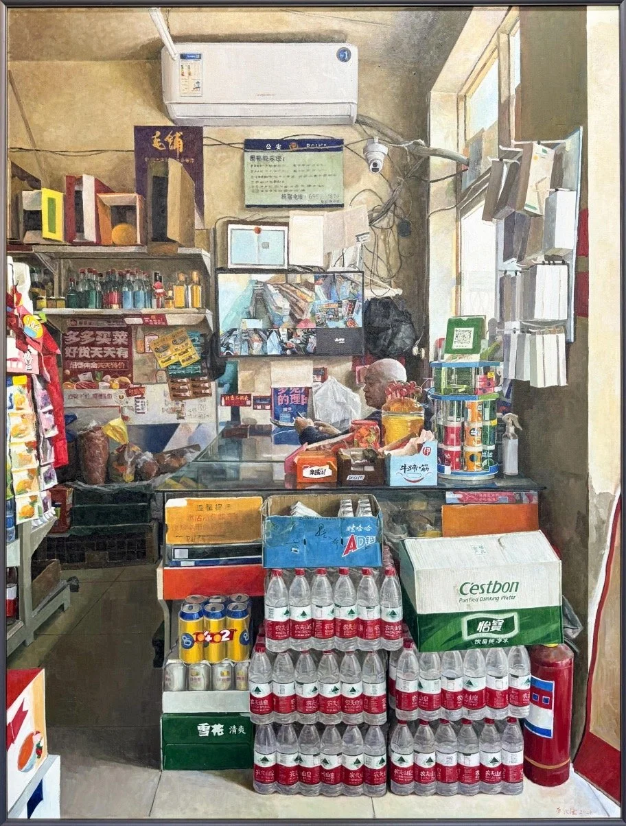 Interior of a small convenience store with various products, a cashier manning the counter, and shelves stocked with beverages, snacks, and other items.