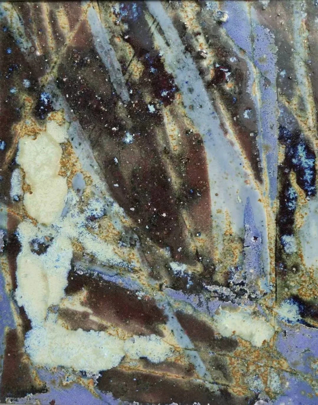 Close-up of rusted, weathered metal surface with various colors, textures, and corrosion patterns.