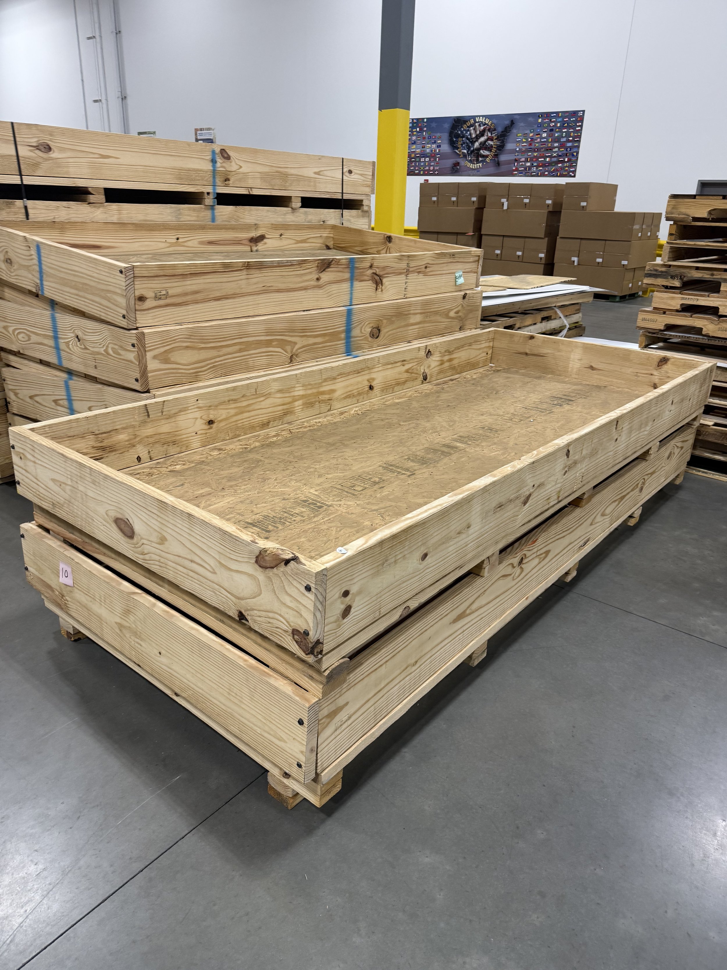 Stacked wooden crates and pallets in a warehouse.