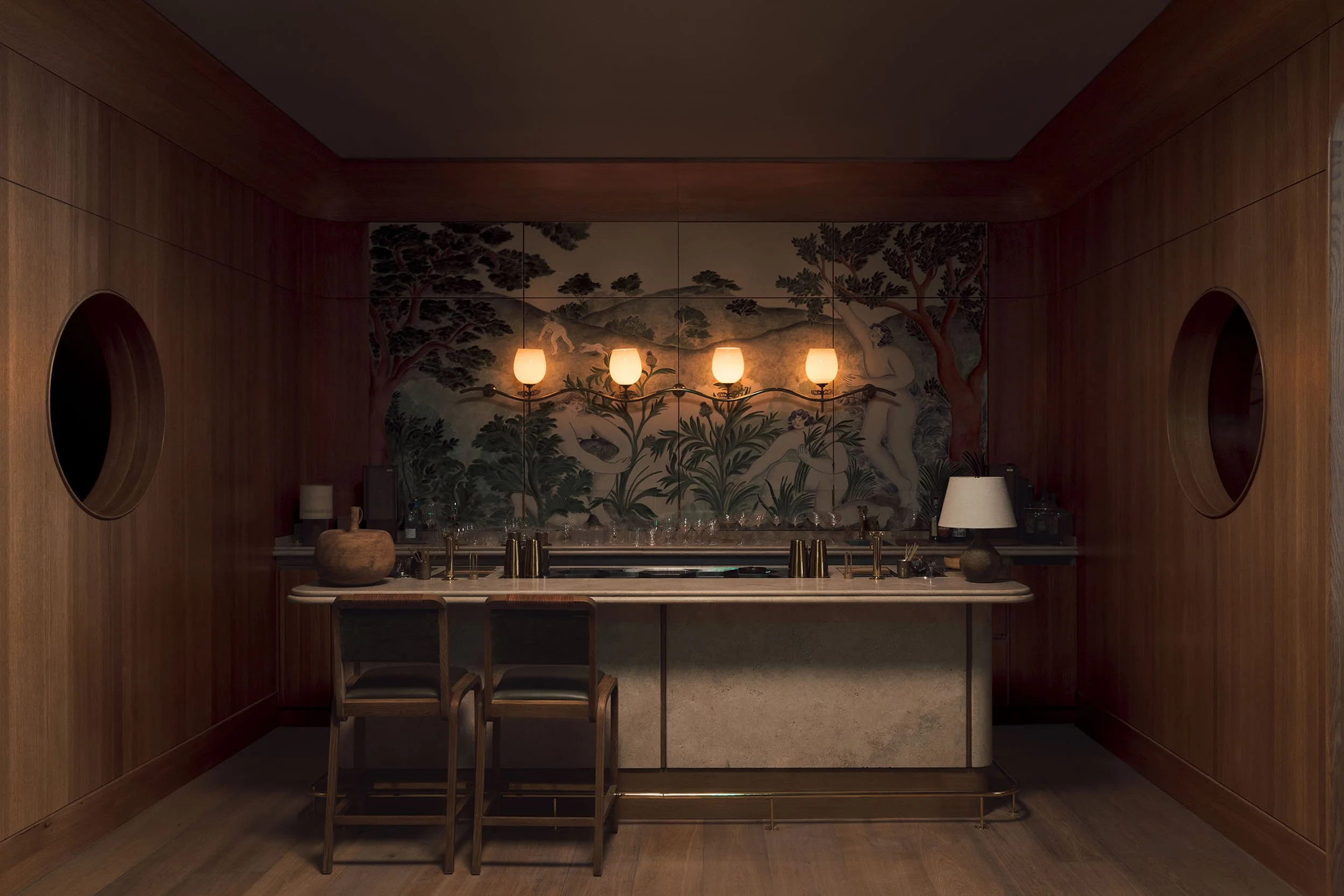 Interior of a room with wood-paneled walls, a backsplash with a nature scene mural, a central chandelier with five lamps, and a kitchen counter with chairs.