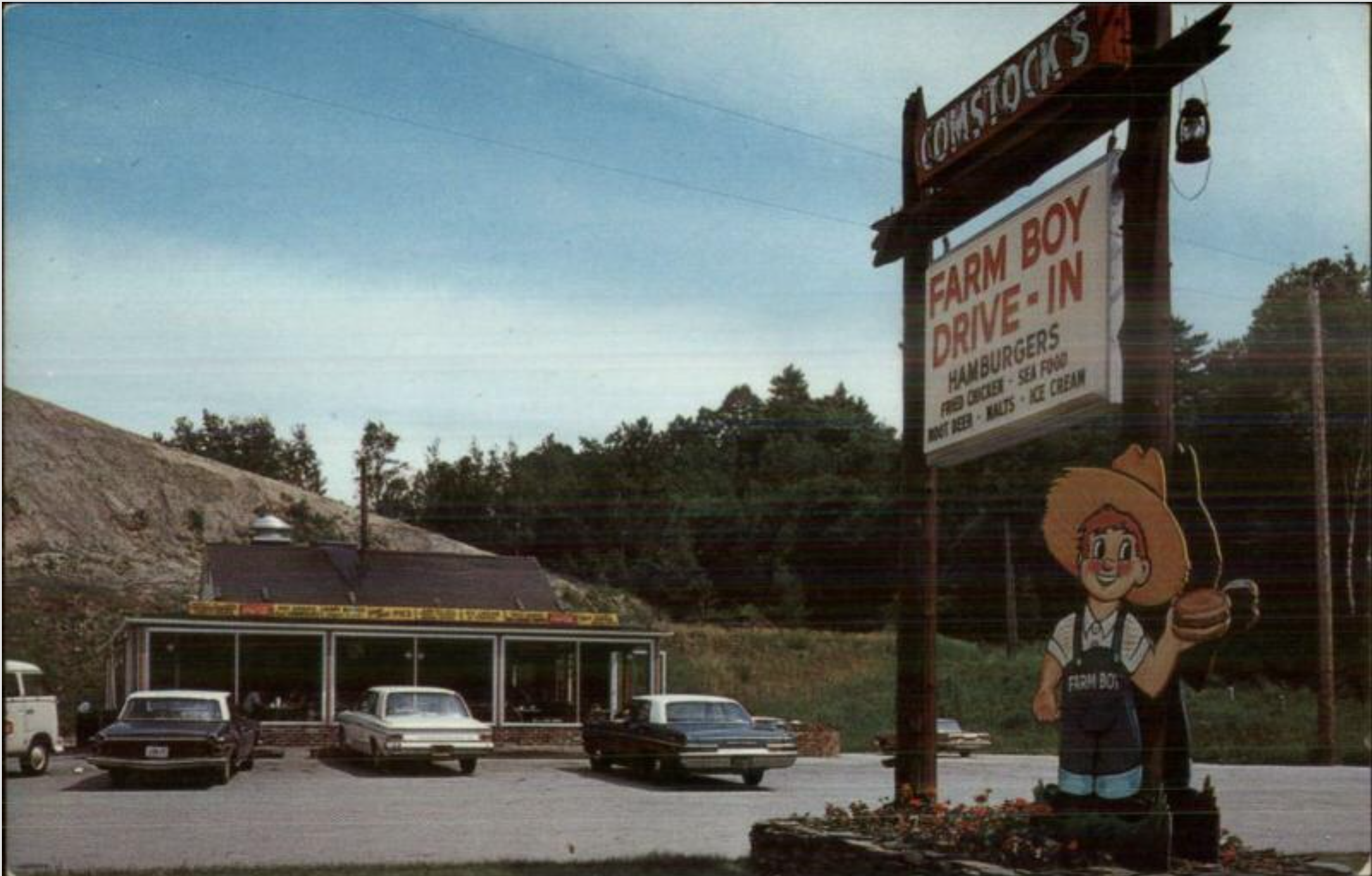 A vintage roadside scene featuring a large sign for 'Farm Boy Drive-In' with a burger, fries, and ice cream listing, and a cartoon mascot of a girl with a hat holding a burger. Below, a parking lot with several cars and a small building, and a background of trees and a hill.