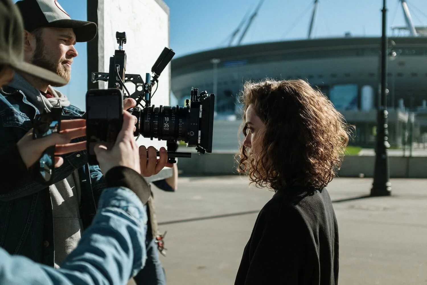 Film crew shooting a scene outdoors with a cinema camera
