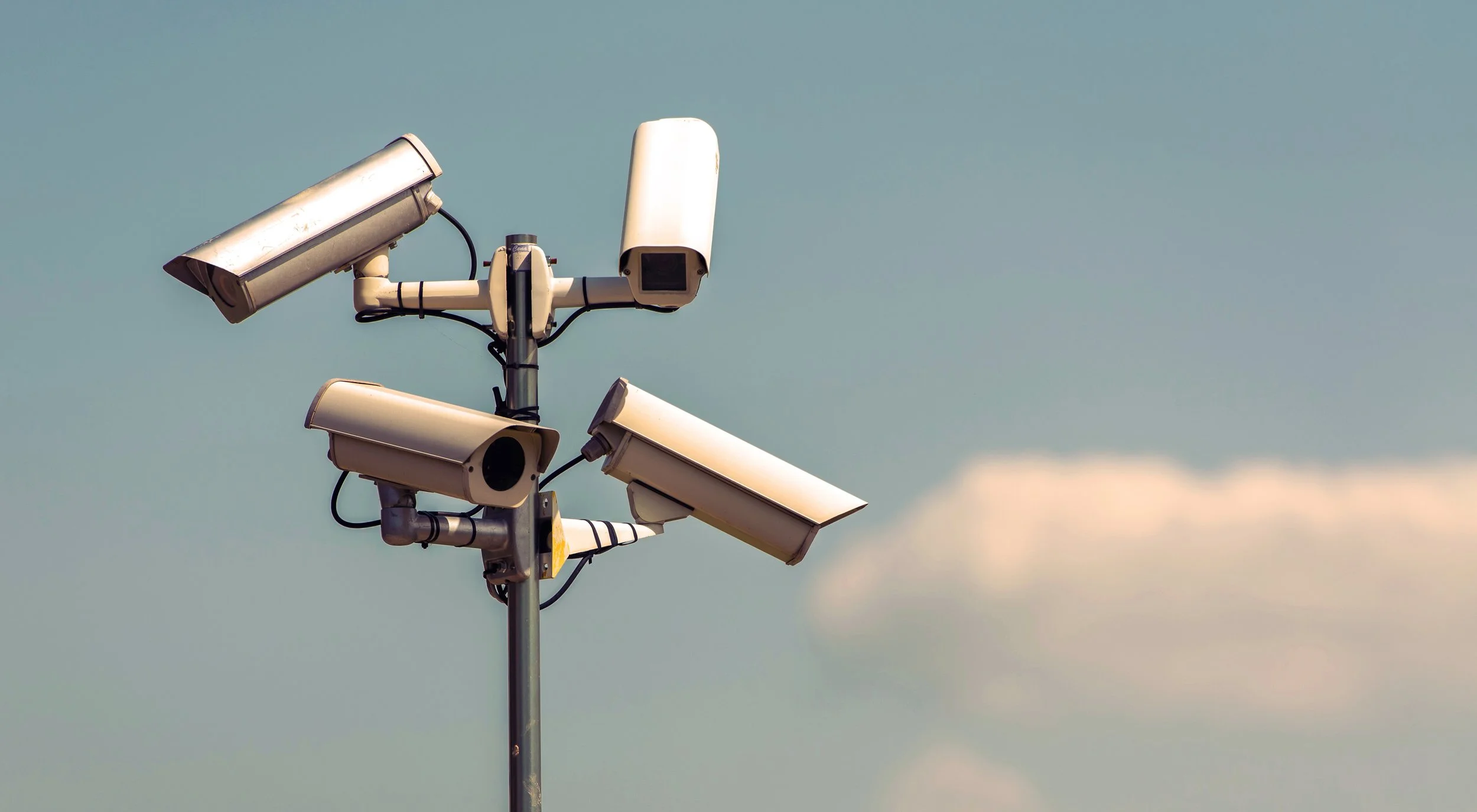 Security Cameras on Blue Sky