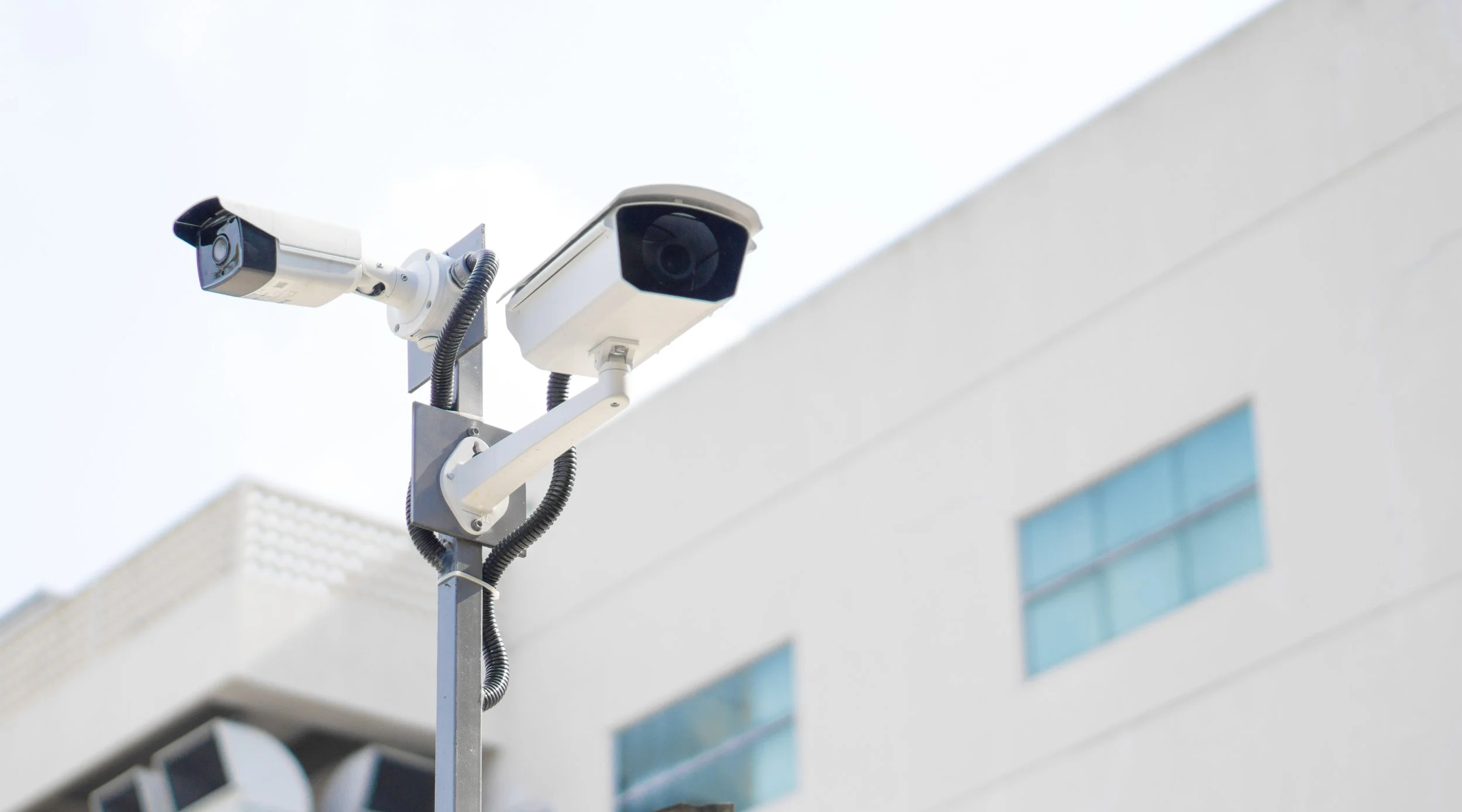 Security cameras in front of industrial building