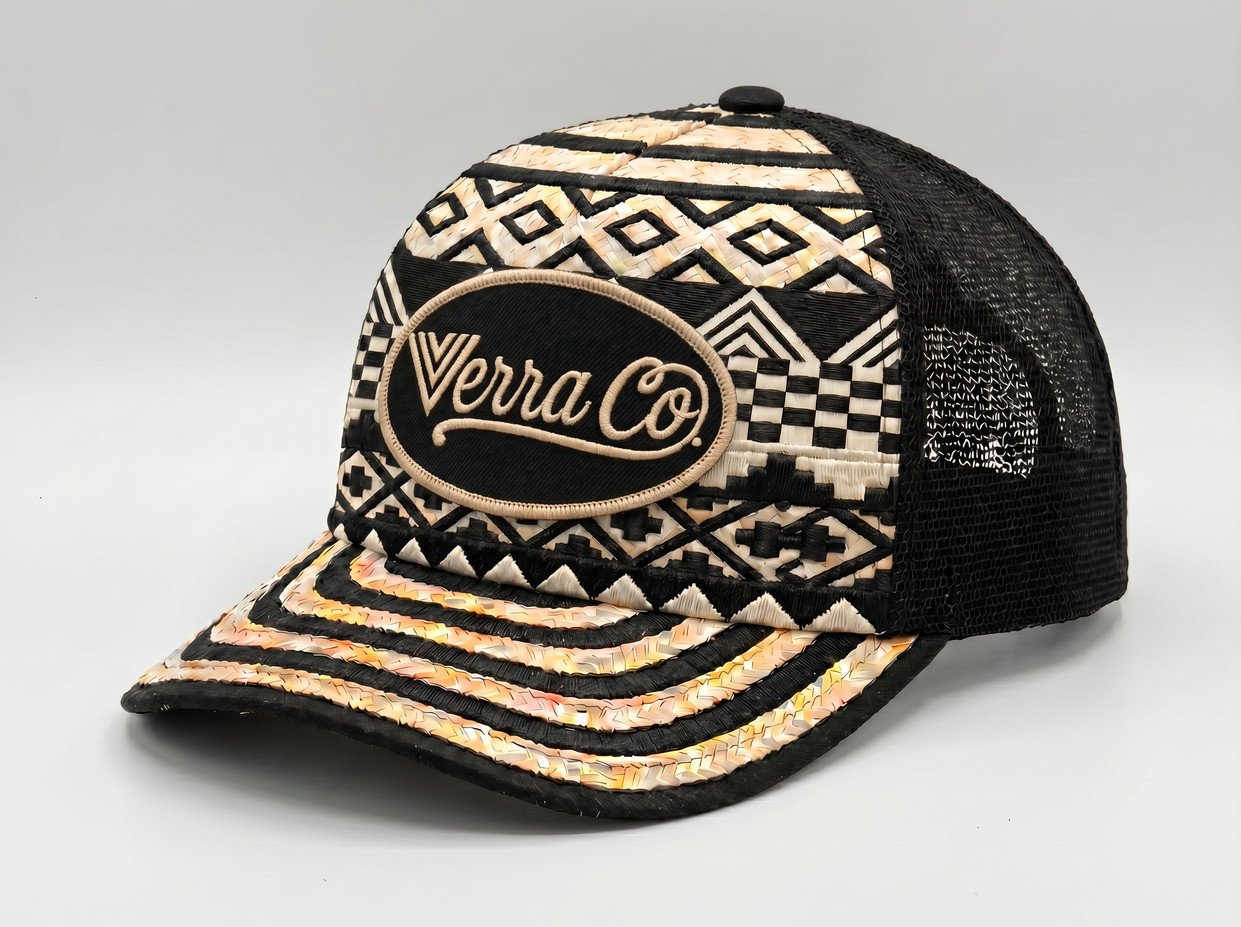 A black and beige trucker-style cap with intricate geometric patterns and an embroidered patch that reads "Verra Co."