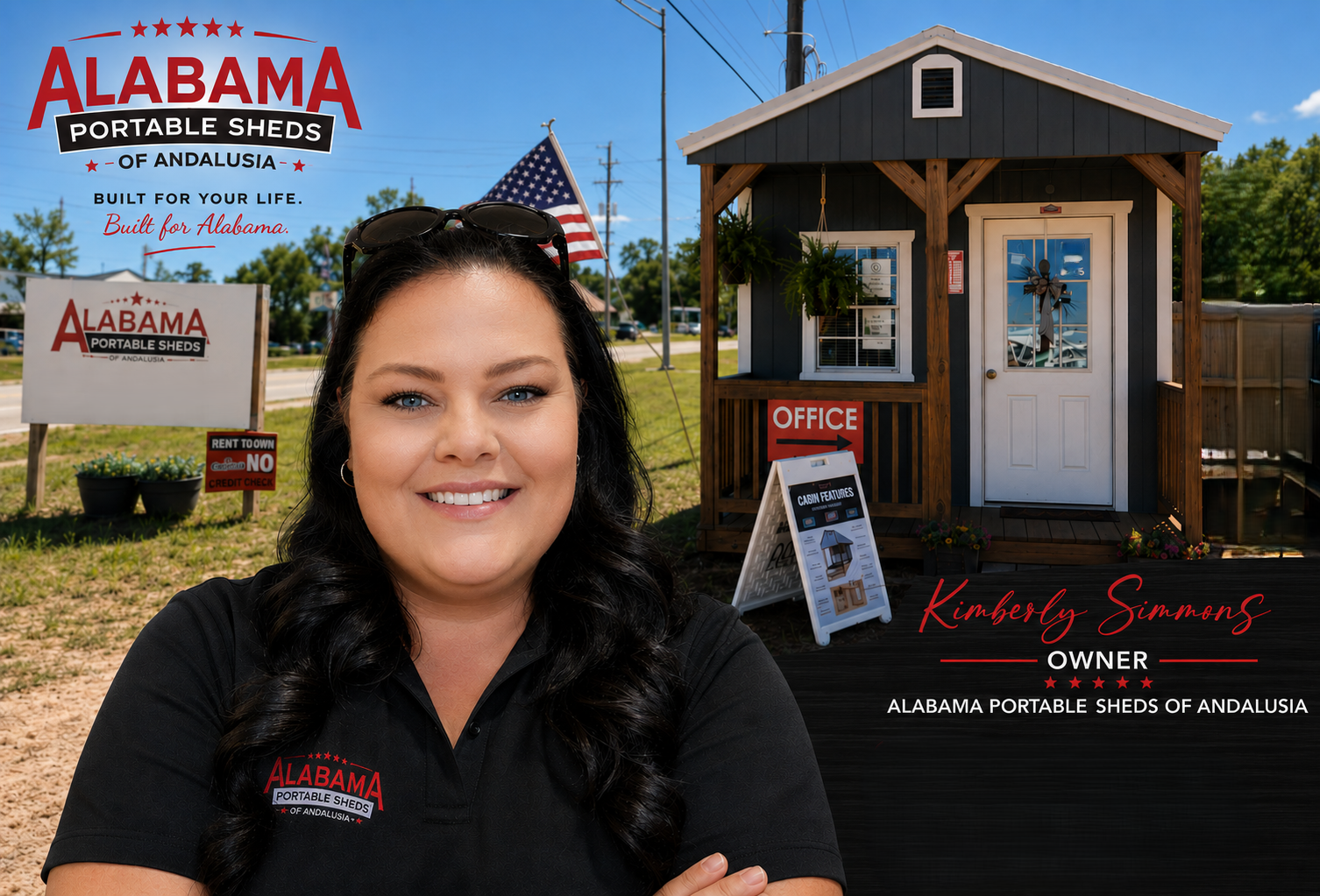 A woman with long dark hair smiling at the camera, wearing a black polo shirt with a logo for Alabama Portable Sheds of Andalusia. In the background, there is a small dark-colored shed with a white door, a sign pointing to the office, another sign detailing the shed features, and an American flag. There are also signs for the business, and the setting appears to be outdoors on a sunny day.