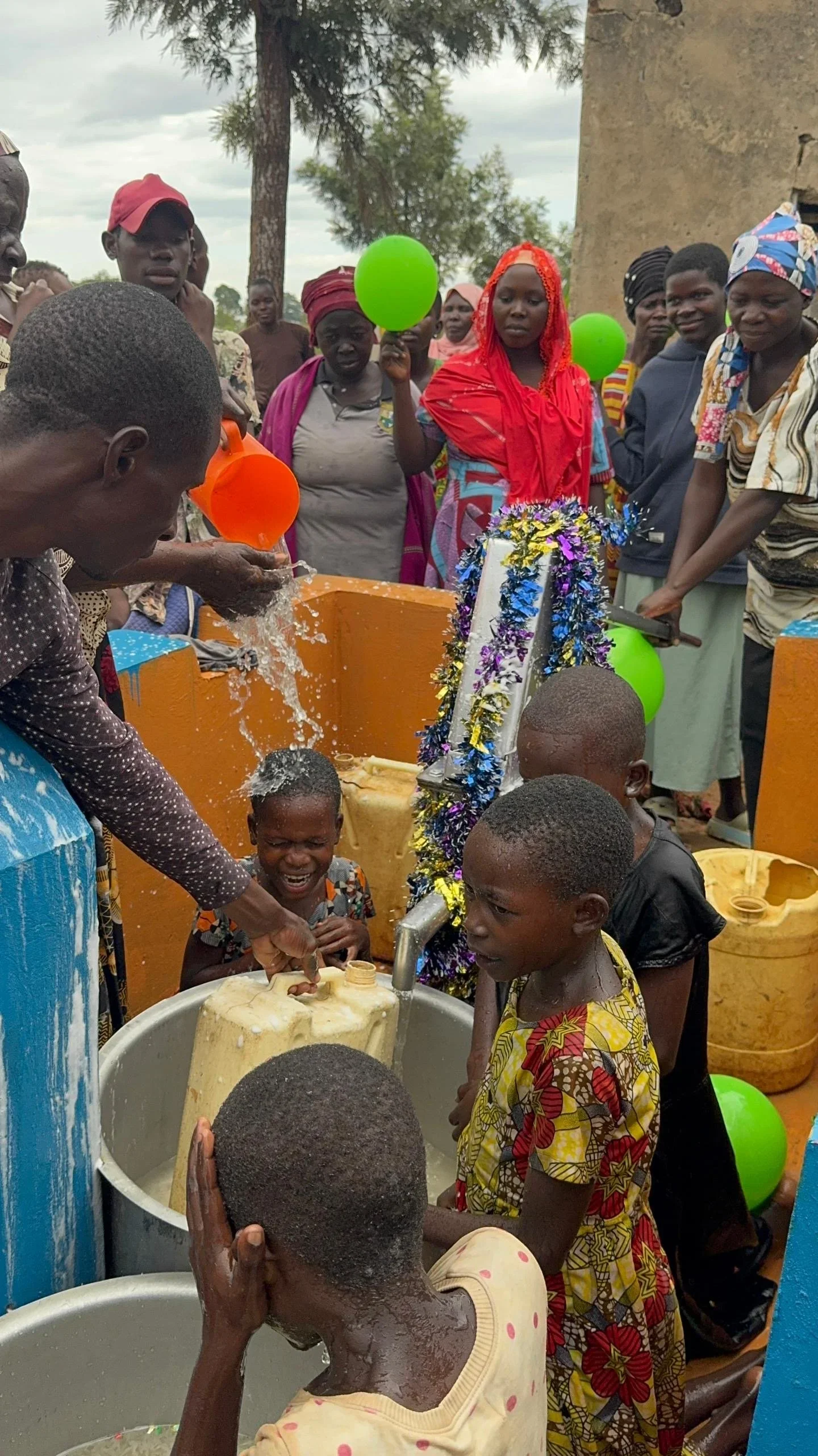 Moazzma Hunain Foundation- impact in Uganda. Children and villagers celebrate the completion of clean water project by Moazzma Hunain Foundation across remote areas in Uganda.