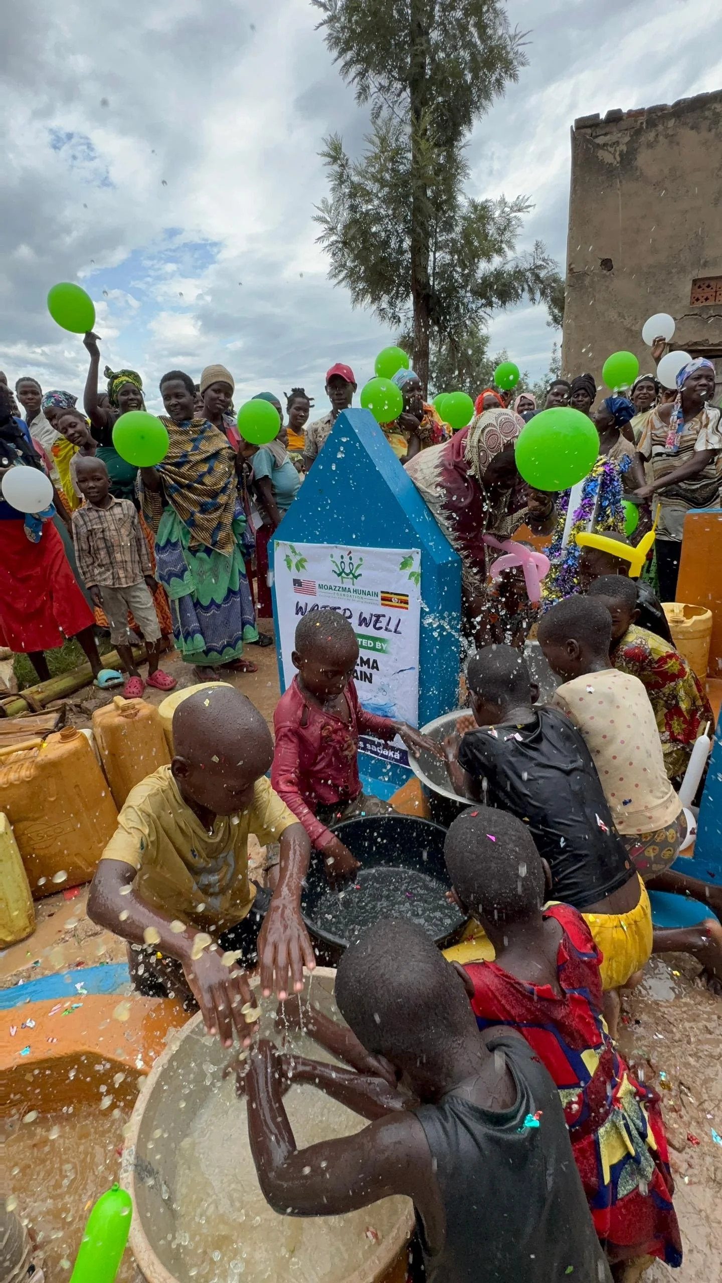 Moazzma Hunain Foundation- impact in Uganda. Children and villagers celebrate the completion of clean water project by Moazzma Hunain Foundation across remote areas in Uganda.