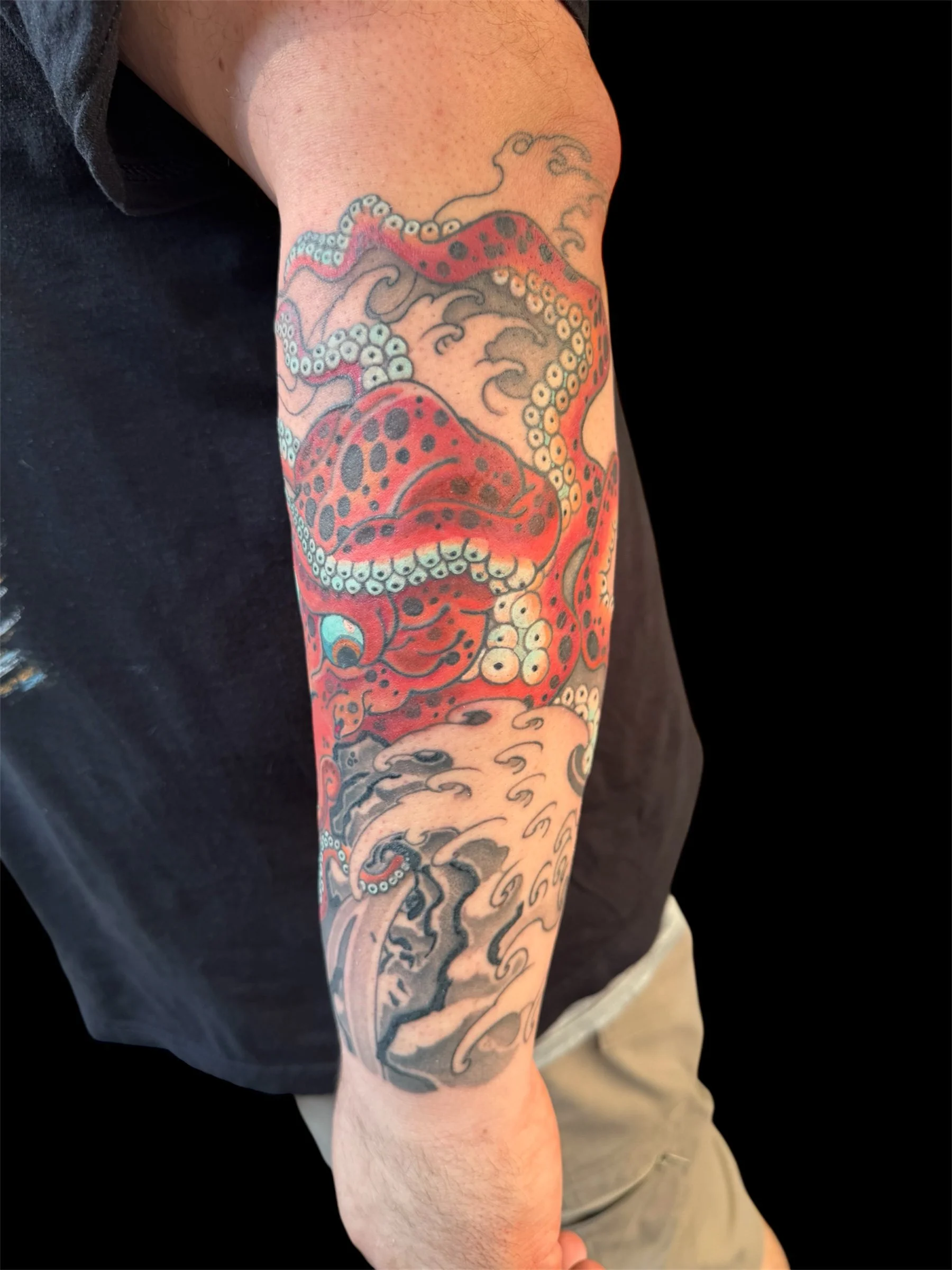 Tattoo of an octopus on a person's forearm.