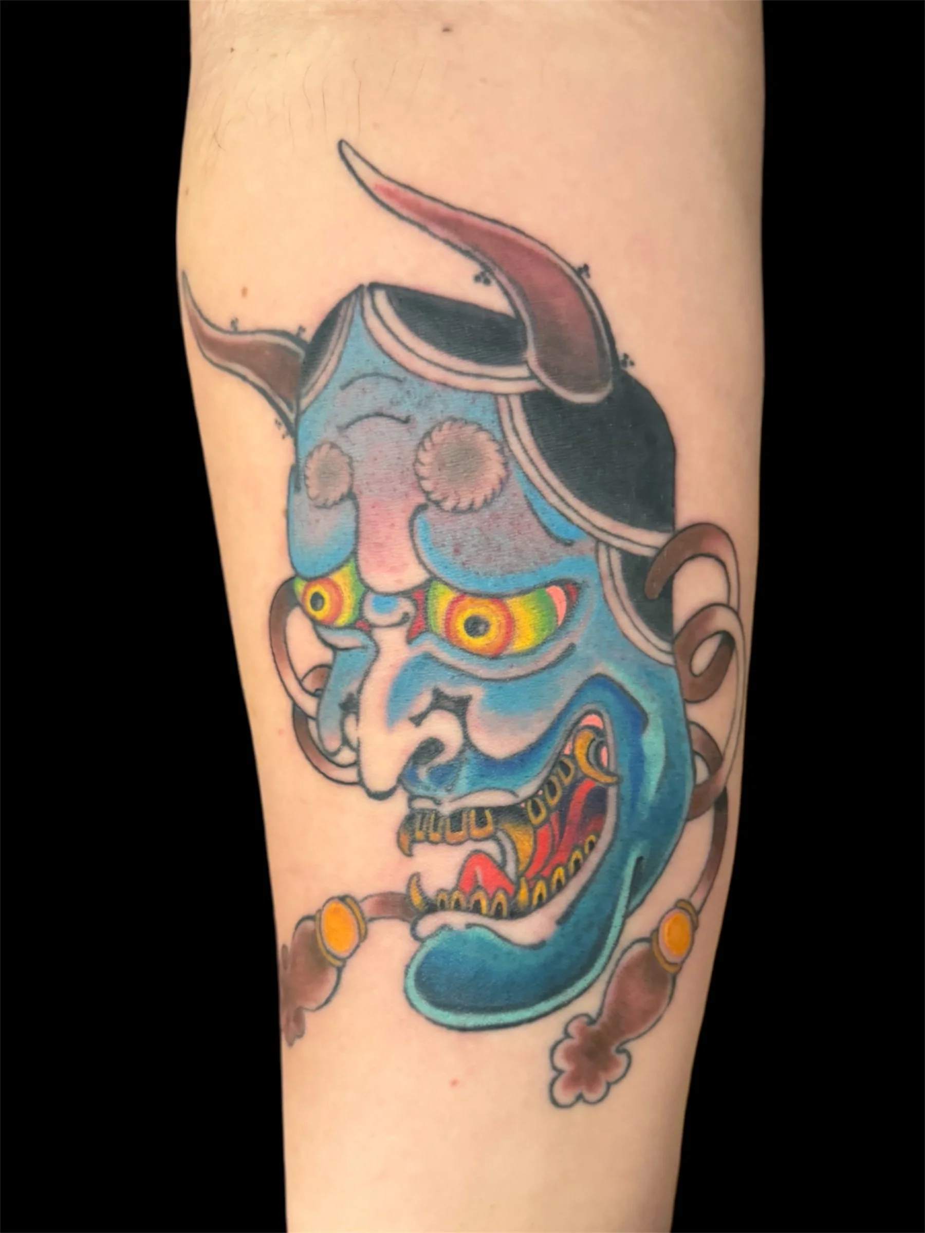 Colorful traditional Japanese dragon tattoo on person's arm.
