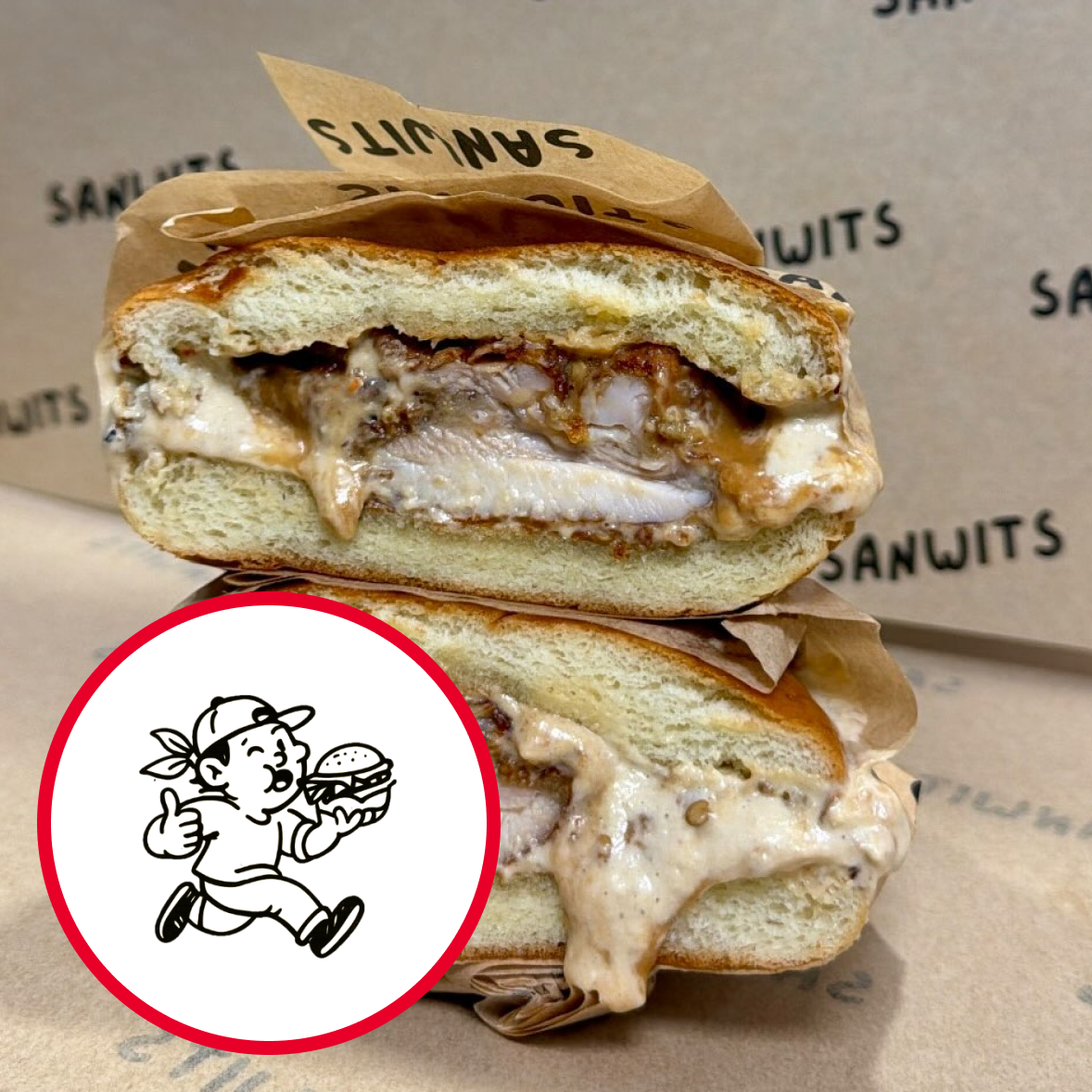 A sliced sandwich with melted cheese and chicken, placed on a paper wrapper that reads 'SanWits' in the background. An illustration of a boy with a cap, running with a burger, MTV style, is overlaid on the bottom left corner.
