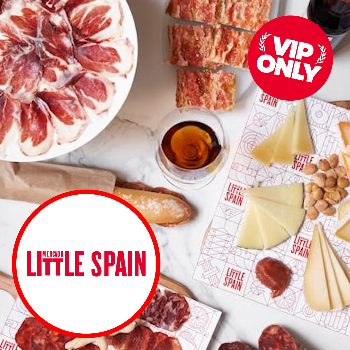 A portrait of a middle-aged male chef wearing a white chef's coat, standing with arms crossed in a restaurant kitchen background. Red circular stickers say 'VIP ONLY' and 'Mercado Little Spain'.