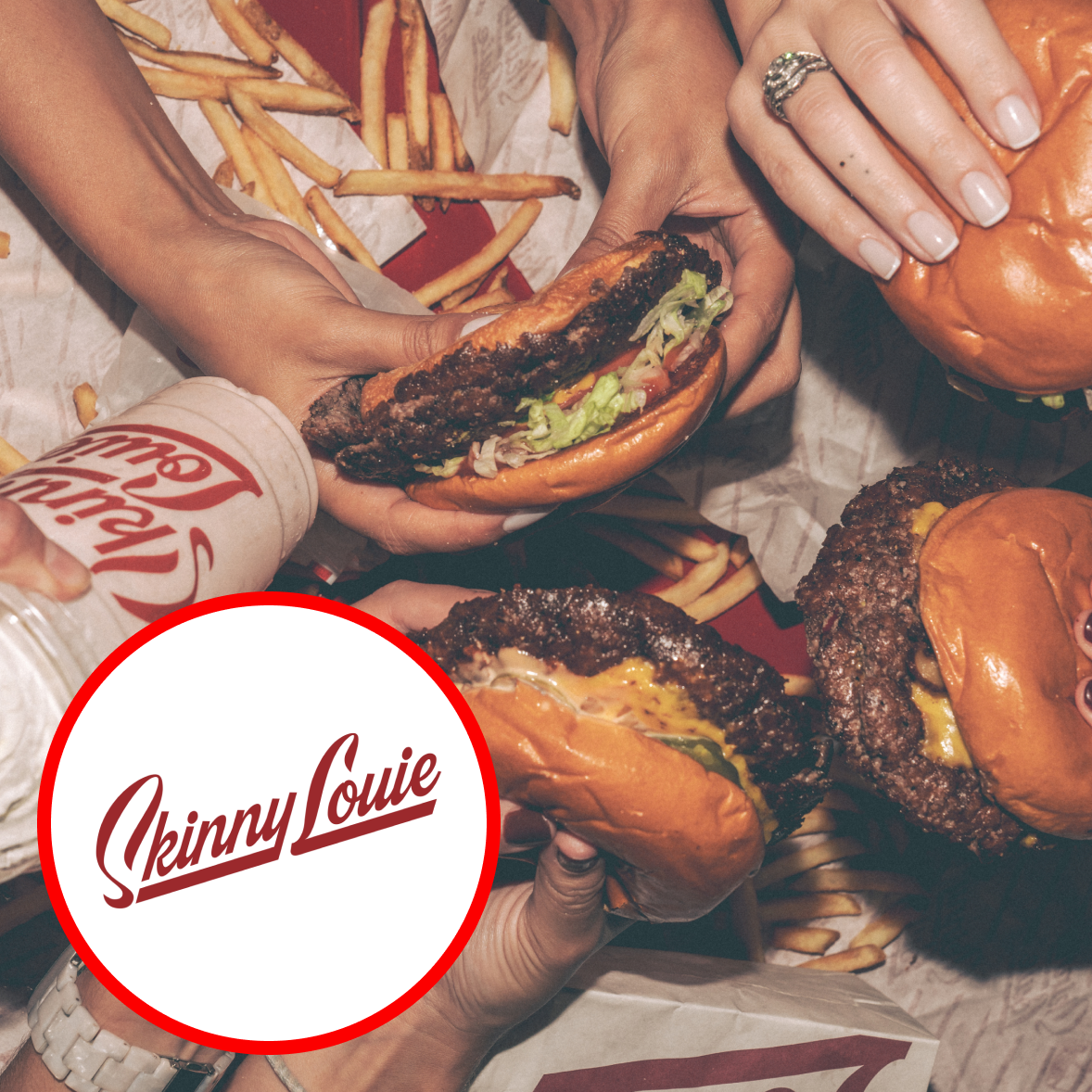 Several people holding burgers with lettuce and tomato, and a side of fries on a tray. The image features a partly visible soda cup with a logo reading 'Skinny Louie.'