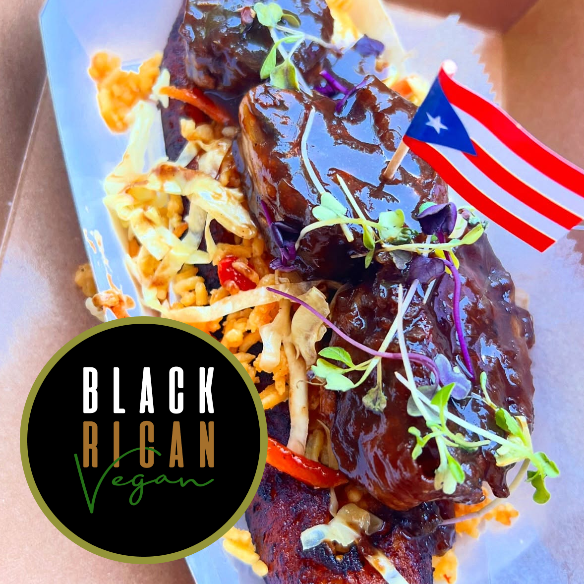 Vegan vegan barbecue dish served on a plate with a small Puerto Rican flag and microgreens, featuring grilled protein with sauce and shredded vegetables.