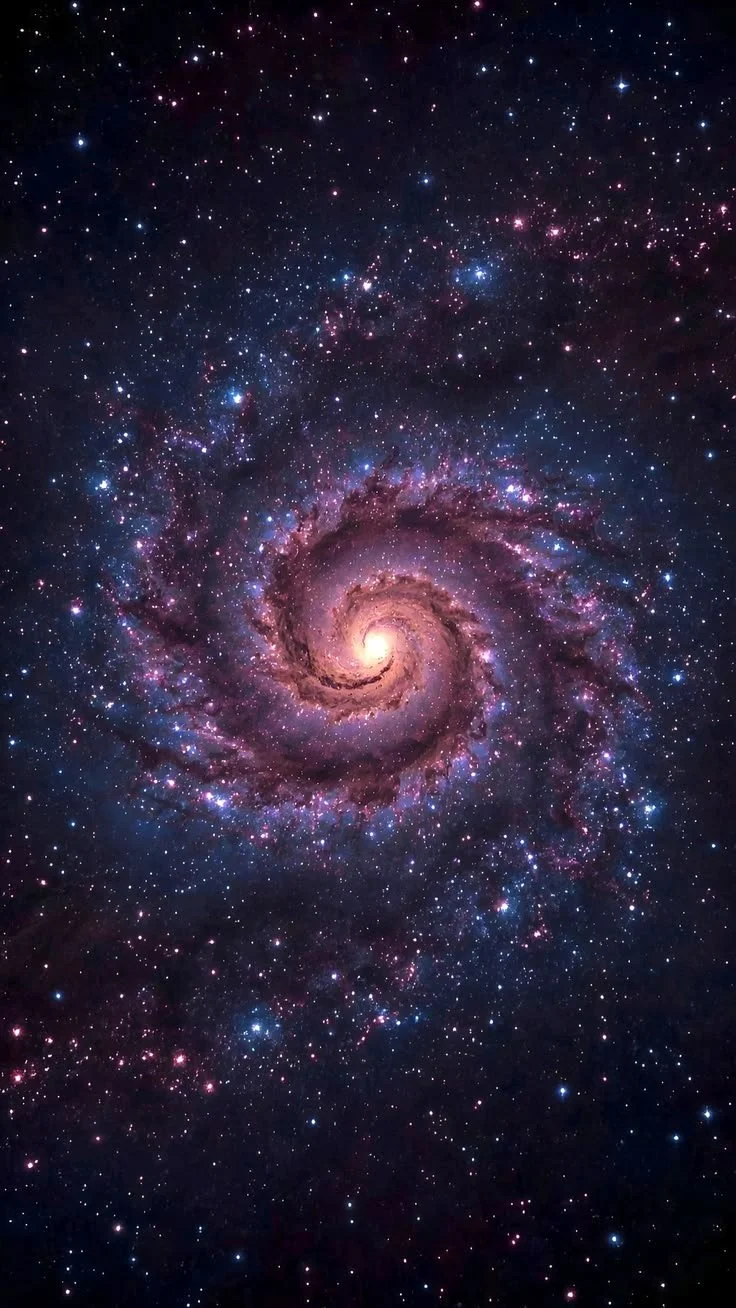 A spiral galaxy with bright pink and purple hues against a background filled with stars.