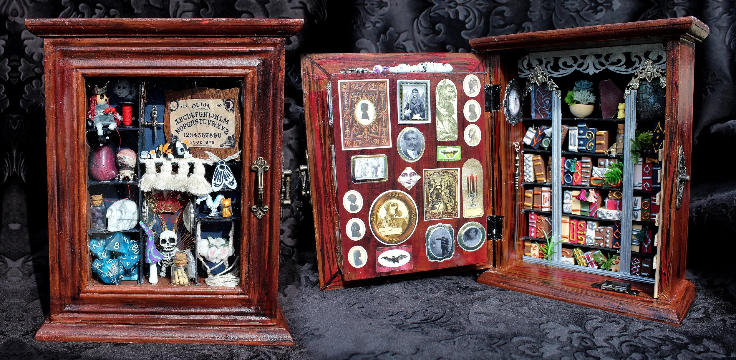 Three wooden display cabinets filled with small collectibles and decorative items, set against a black fabric background.